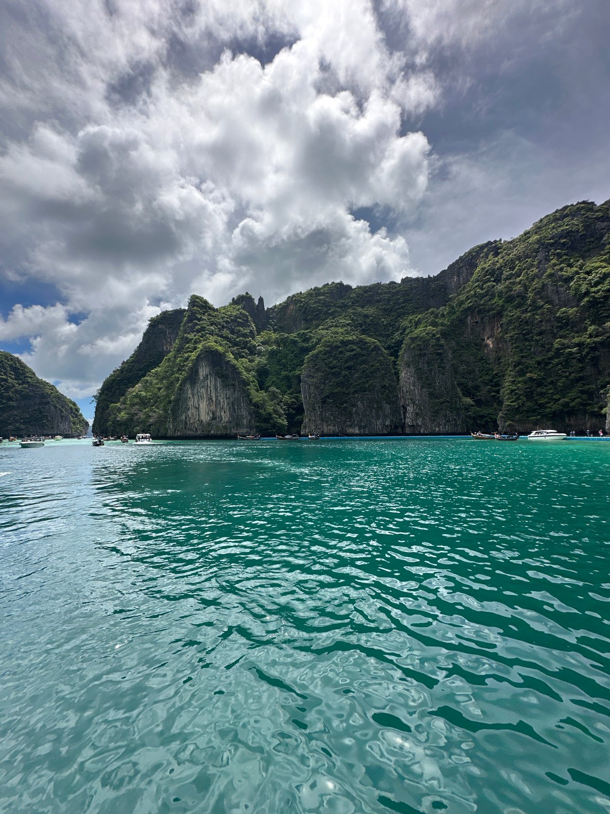 Longtail boats and limestone karsts on Ao Nang's turquoise water