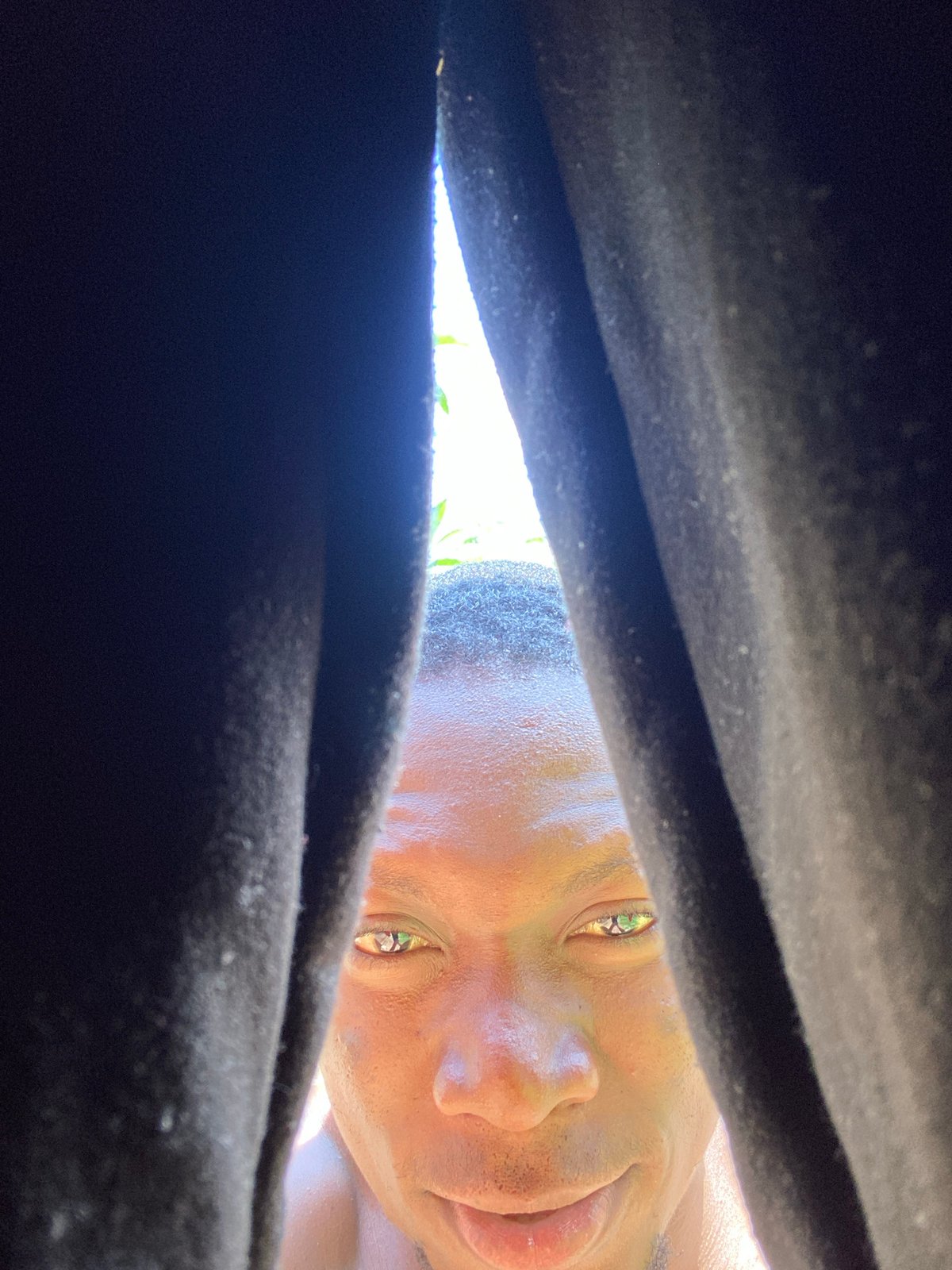 Low-angle selfie sequence under bright Bukuru skies
