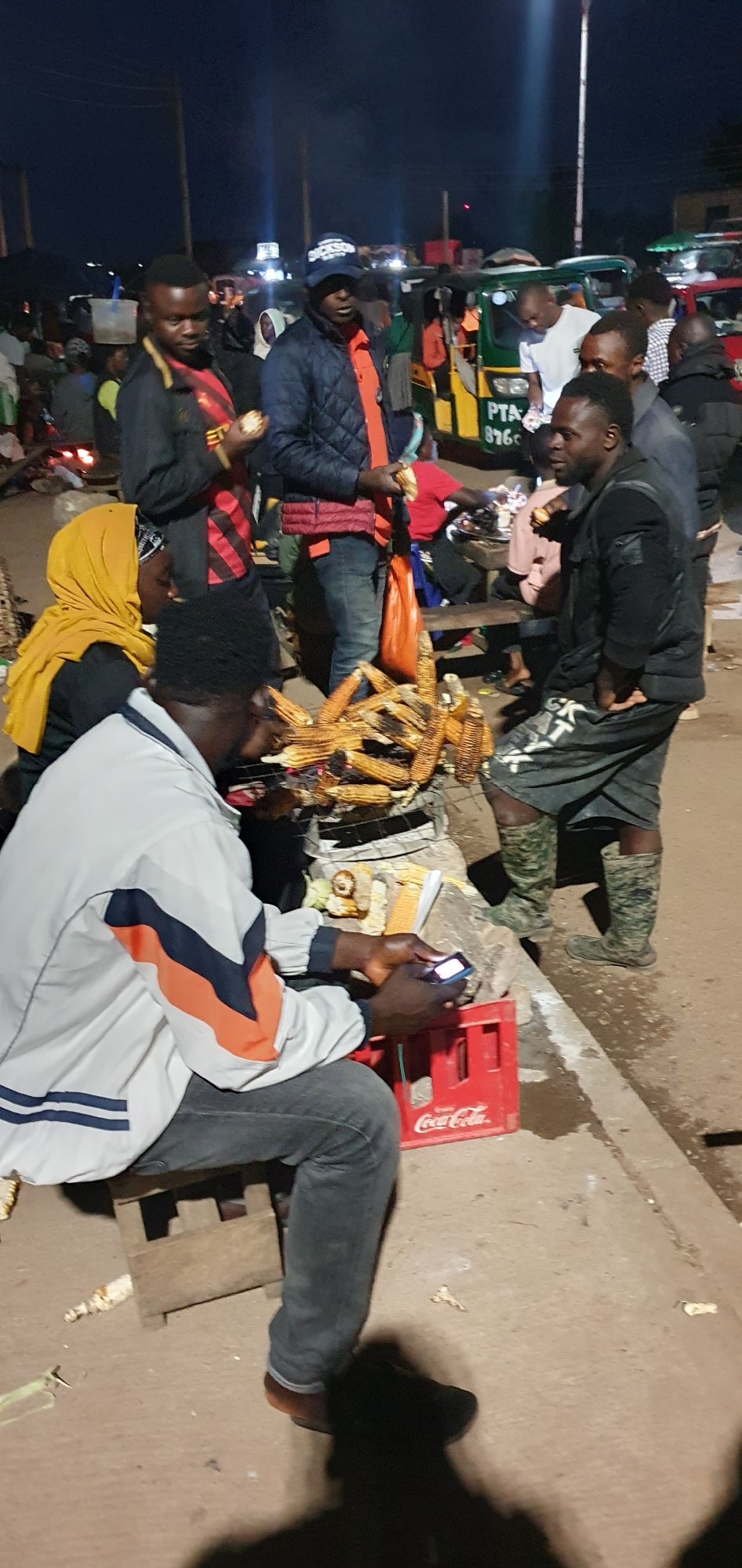 Night market vendors selling corn and fruit in Bukuru, Nigeria