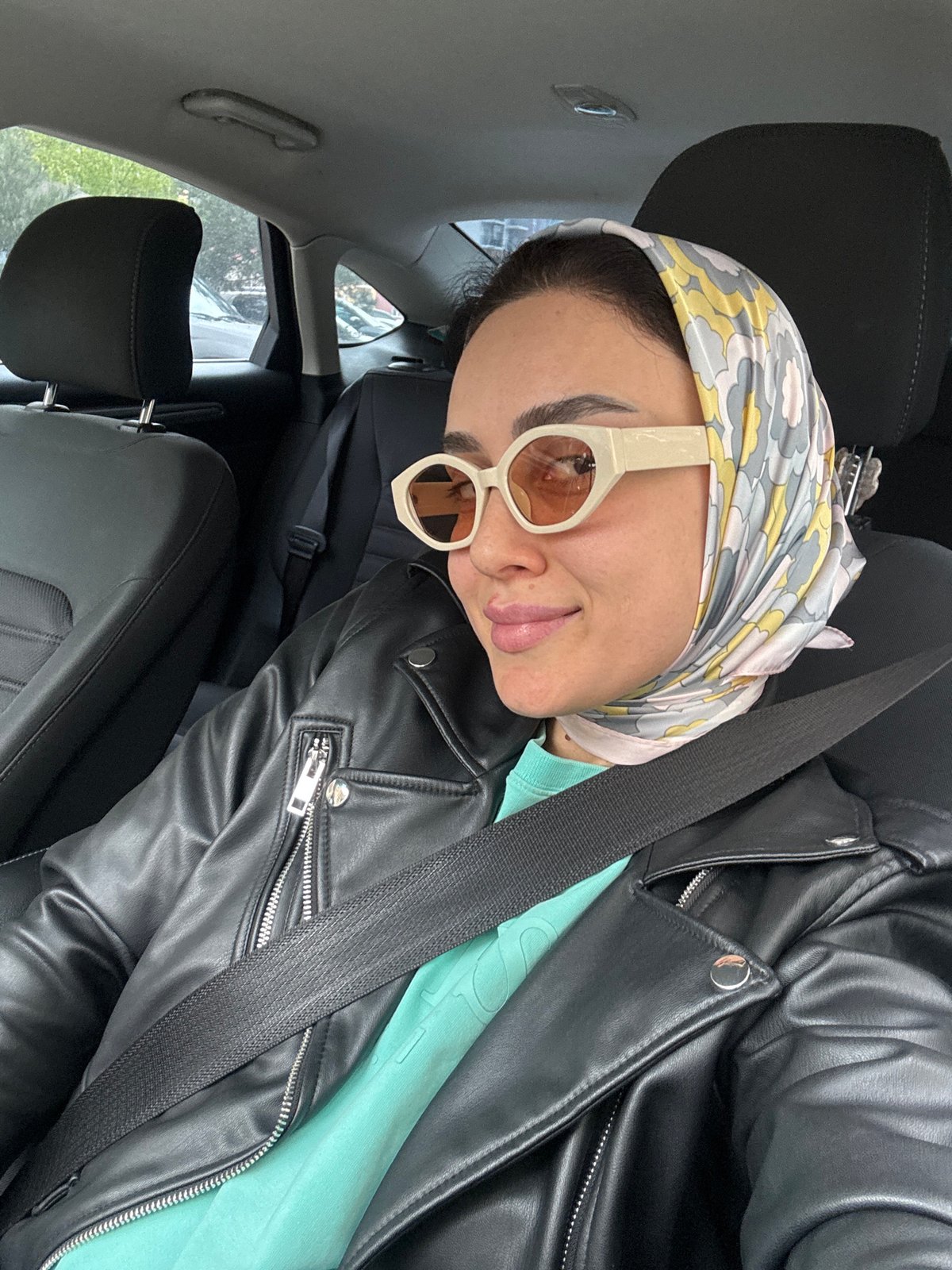 Woman in headscarf photographed in car, Tbilisi