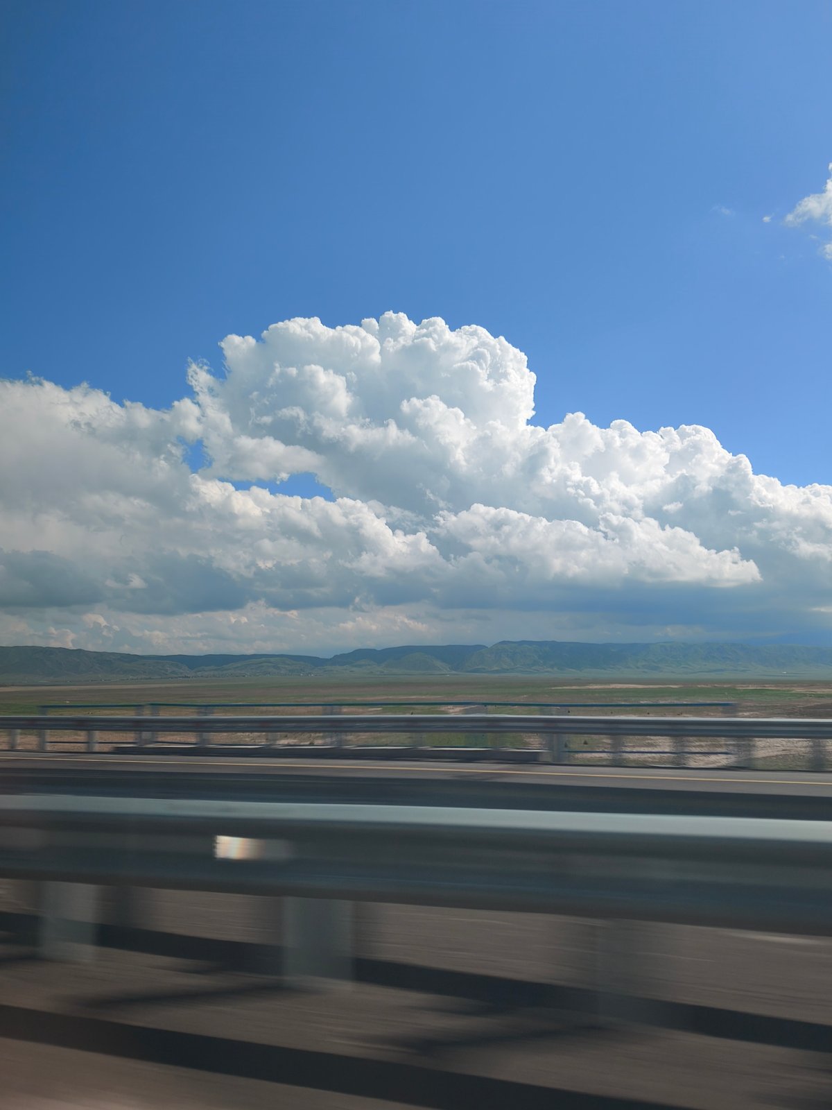 Highway travel captured across Kazakhstan's vast landscape