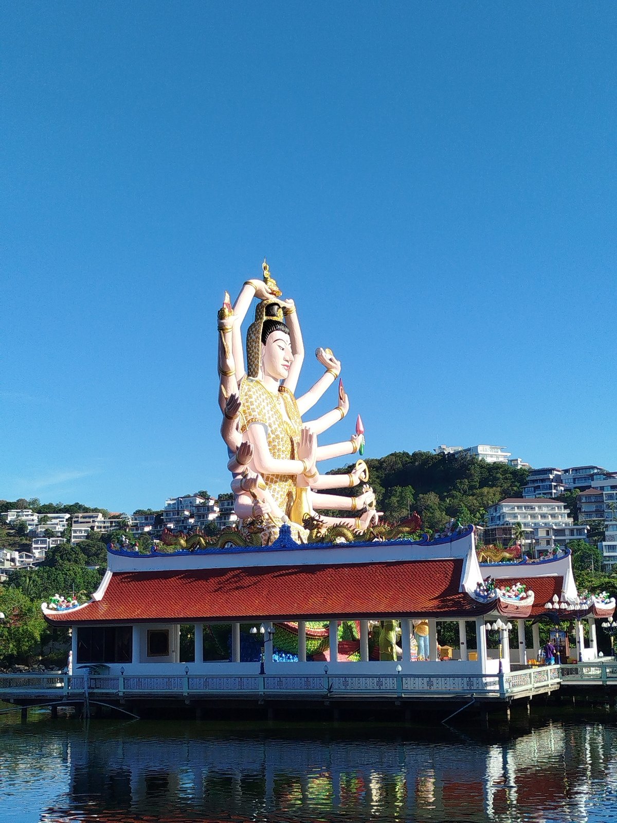 Visitor documents Wat Plai Laem temple complex in Thailand