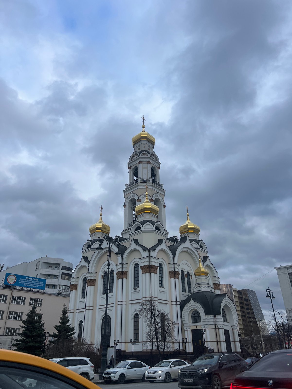 Visitors document Church on Blood in Yekaterinburg under cloudy skies
