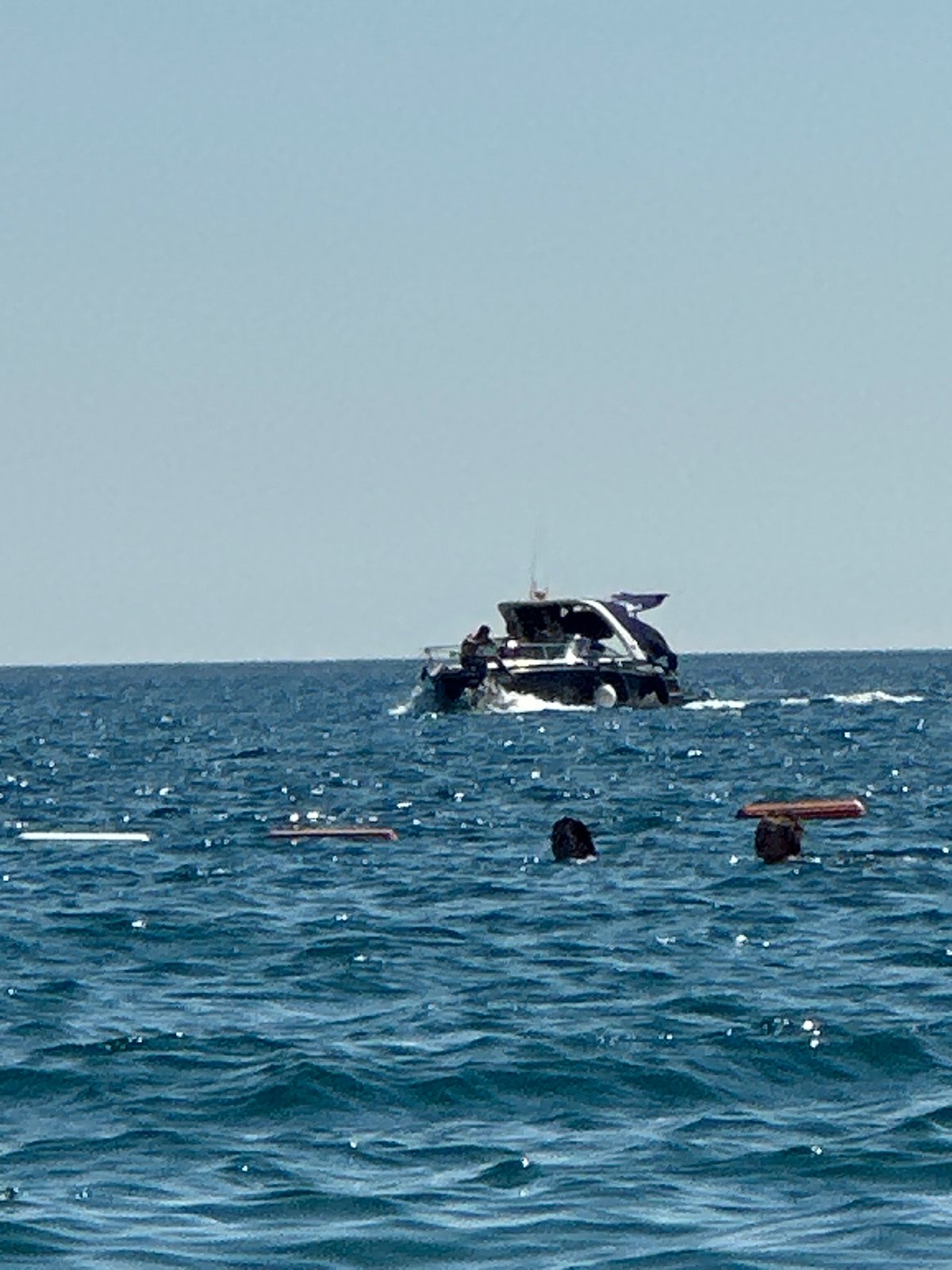 Yacht, paragliders, and a bike-paddleboard on the Adriatic