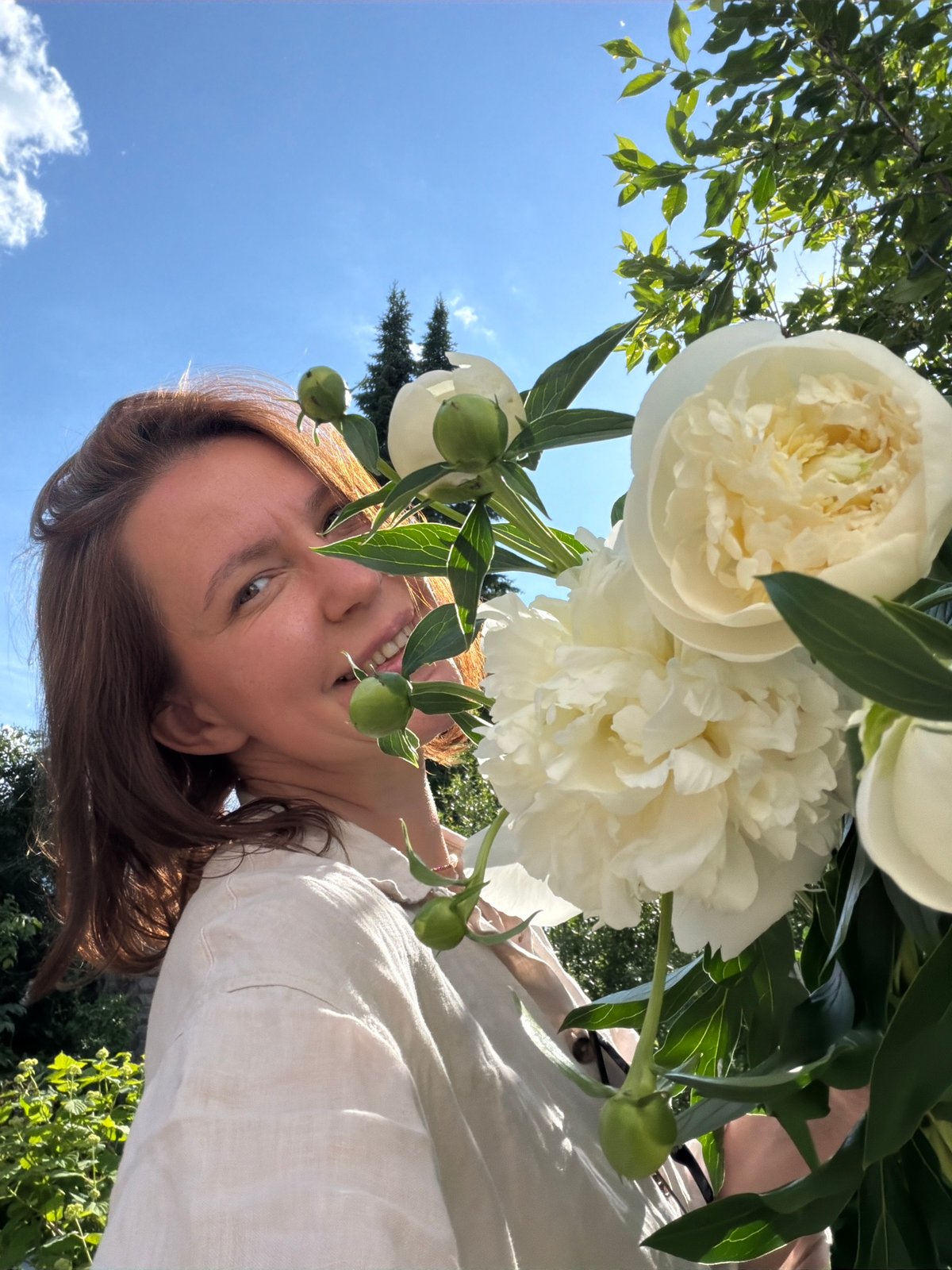 Woman photographed in blooming garden in Прикамский, Russia