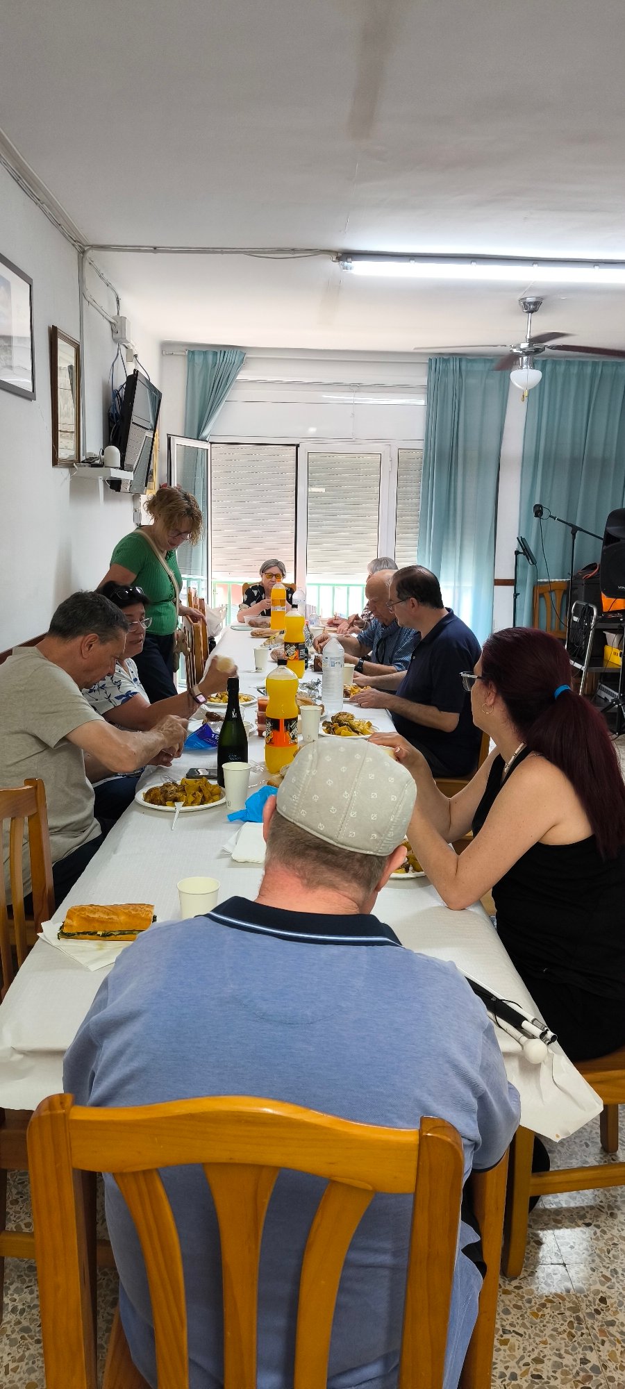 Nine people gather for meal in Ripollet dining room