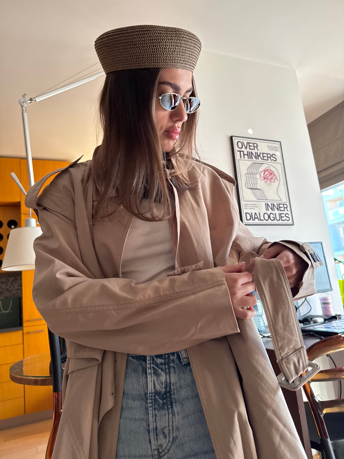 Woman adjusts outfit indoors during afternoon hours