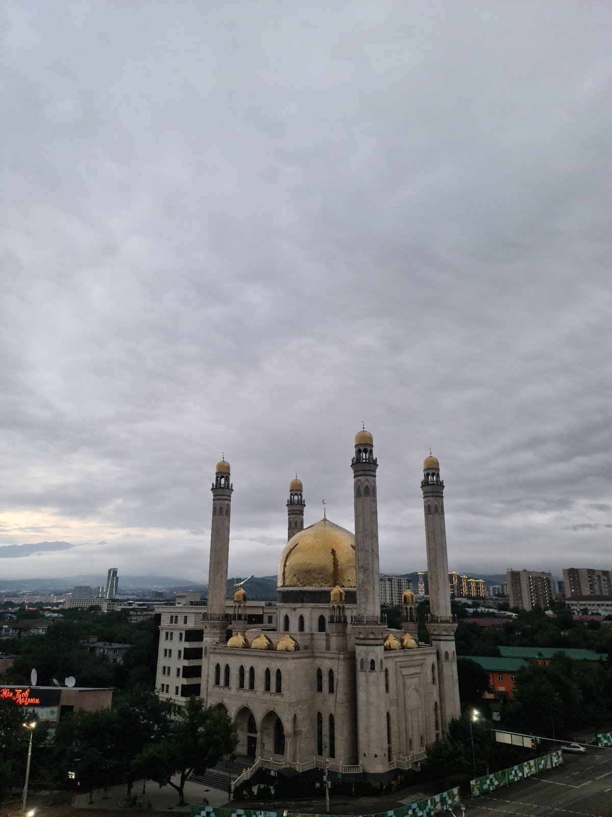 Almaty at dusk: the Central Mosque and city under heavy cloud