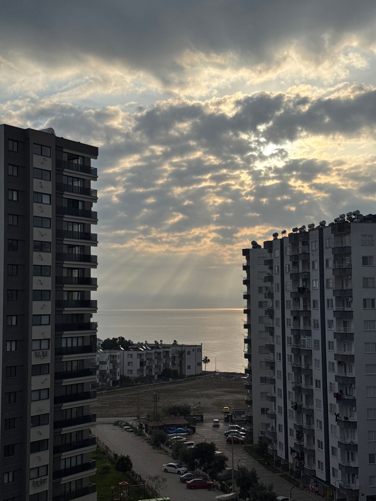 Dawn light breaks through clouds over Erdemli coastline