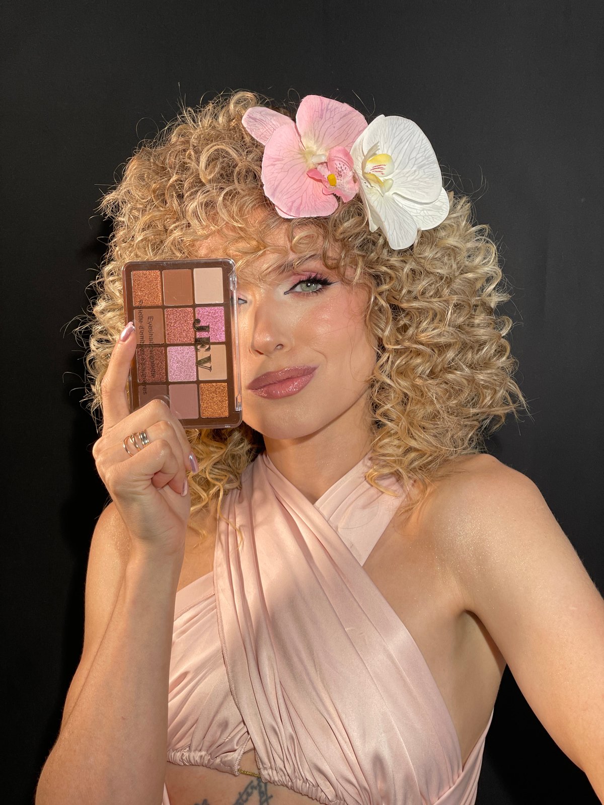 Woman poses with makeup palette in Vysokaya Gora