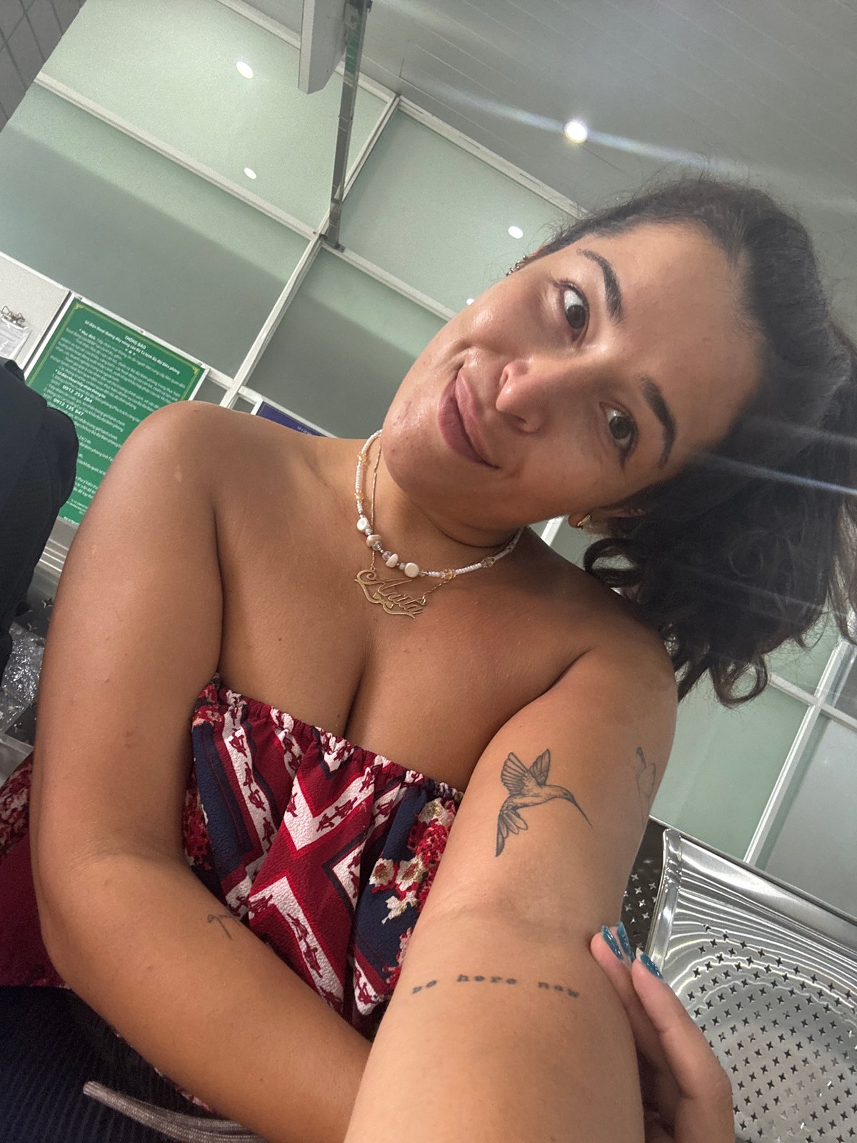 Indoor selfie in Ben Cau, patriotic-patterned top and pearls