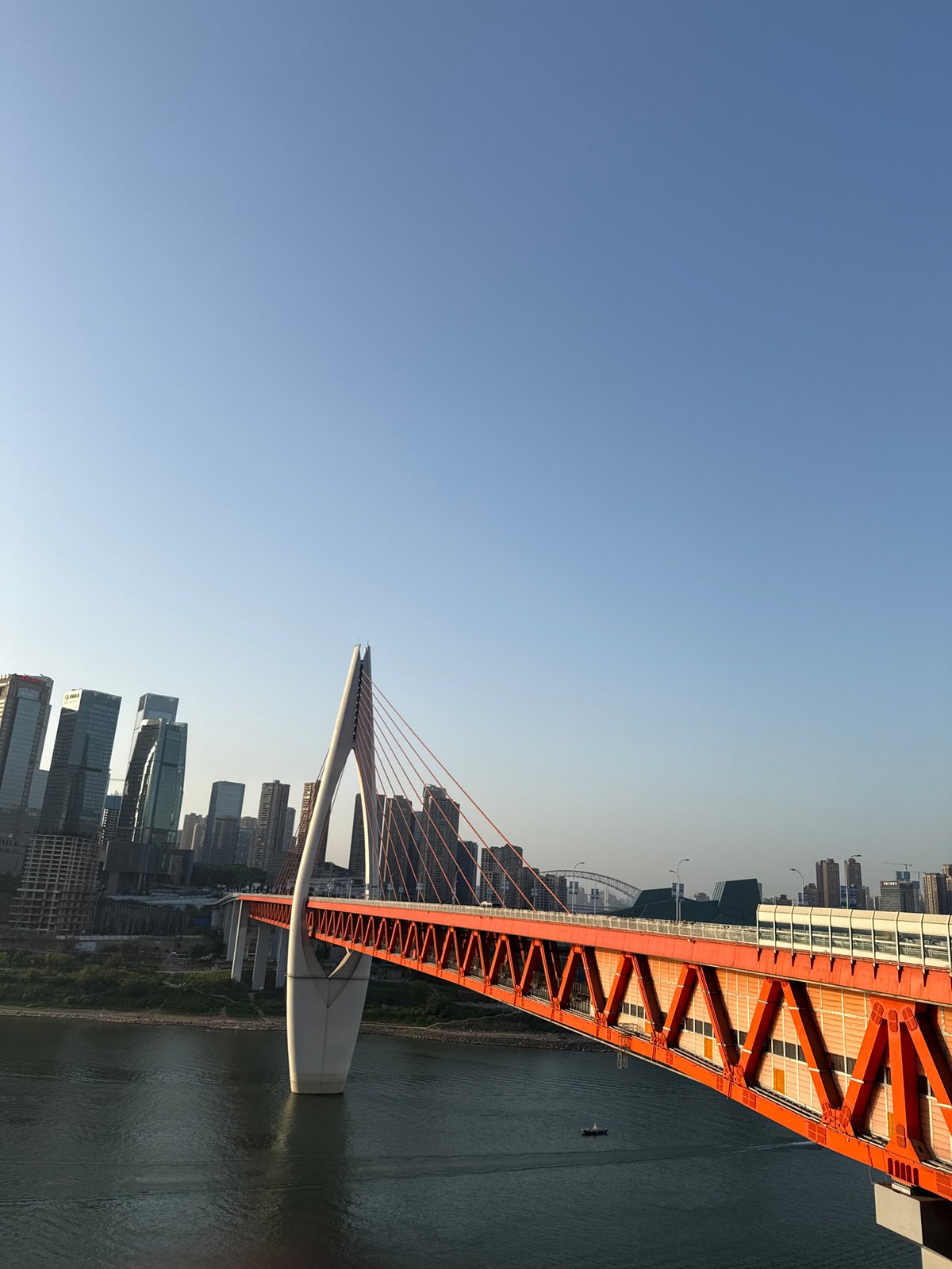 Tourists pose with statues near Chongqing's Hongyadong Bridge