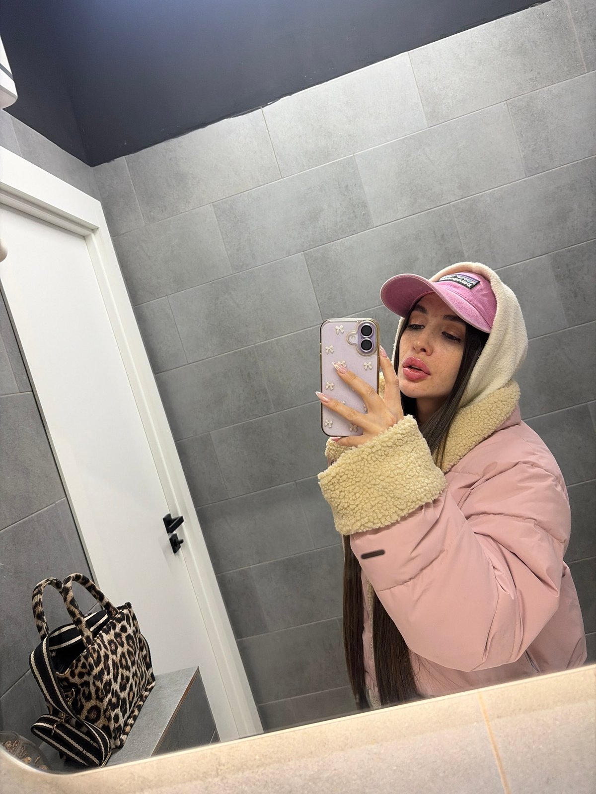 Woman takes bathroom selfies in pink outfit, Saint Petersburg