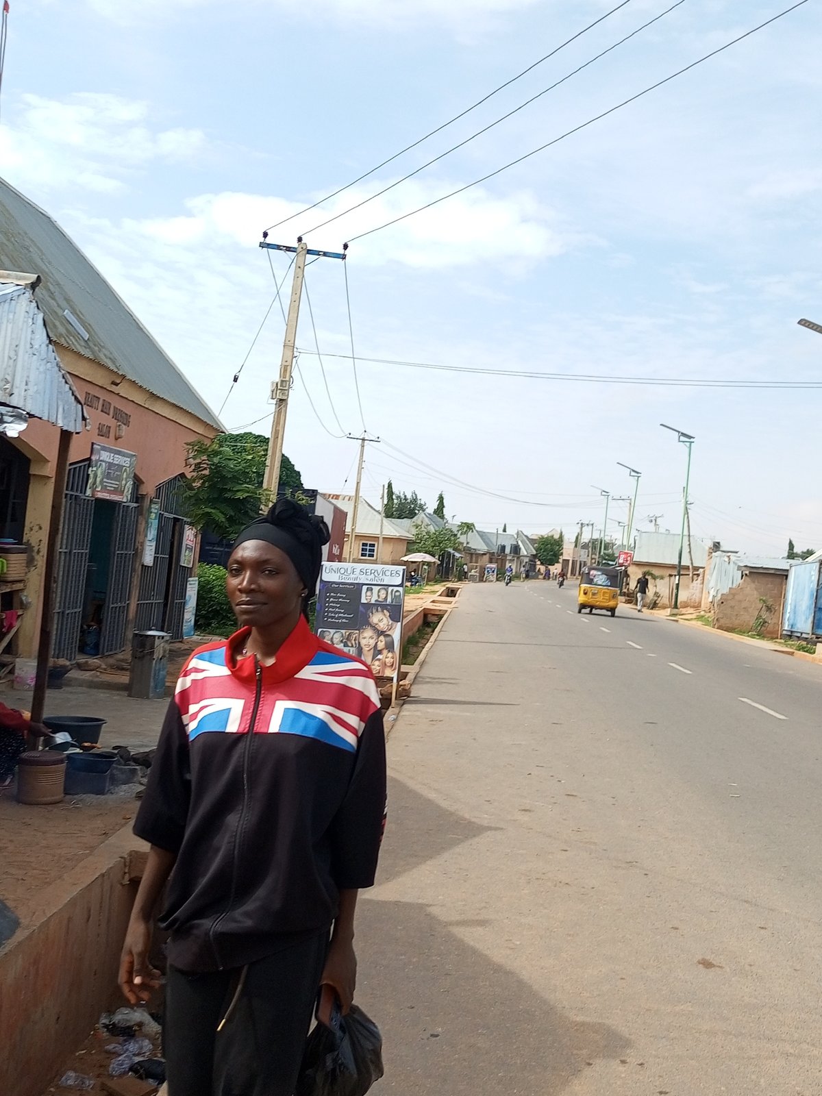 Union Jack jacket on a settlement sidewalk