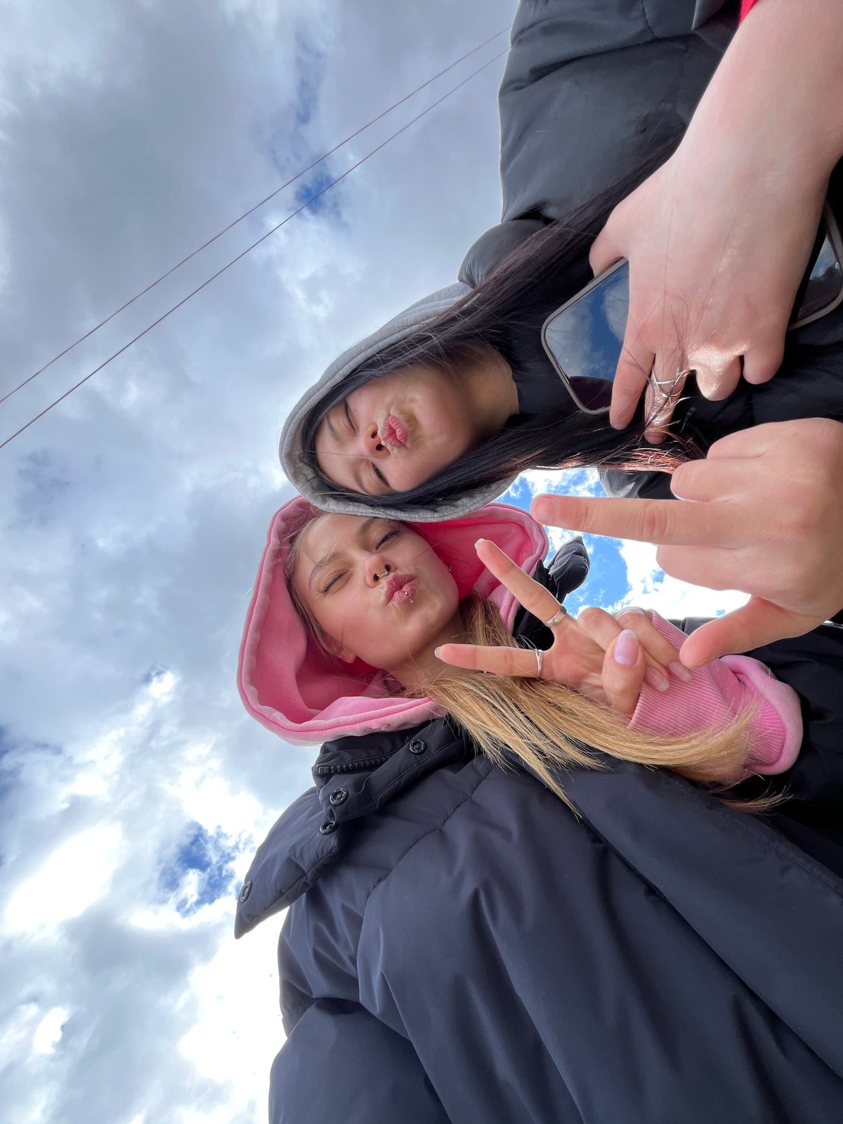 Friends take early morning selfies on bridge in Chaikovsky