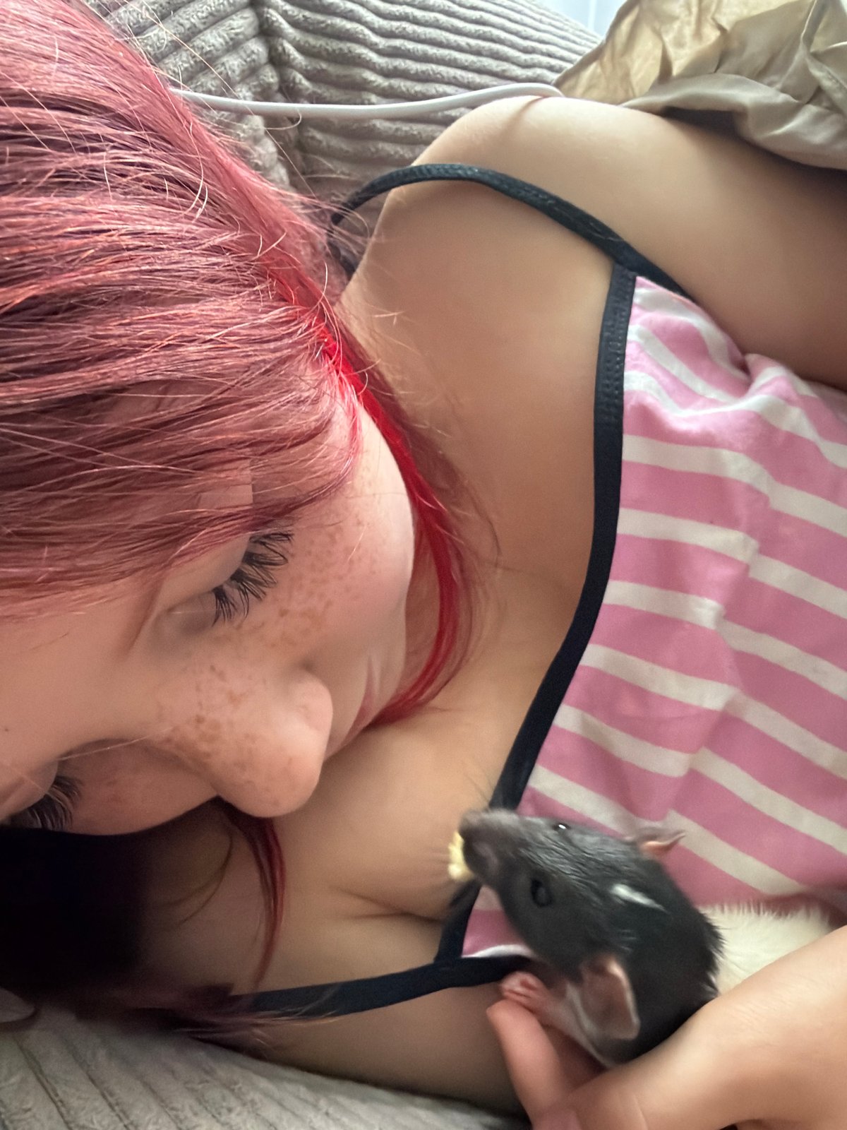 Young person feeds pet rat in Dubovaya, Russia