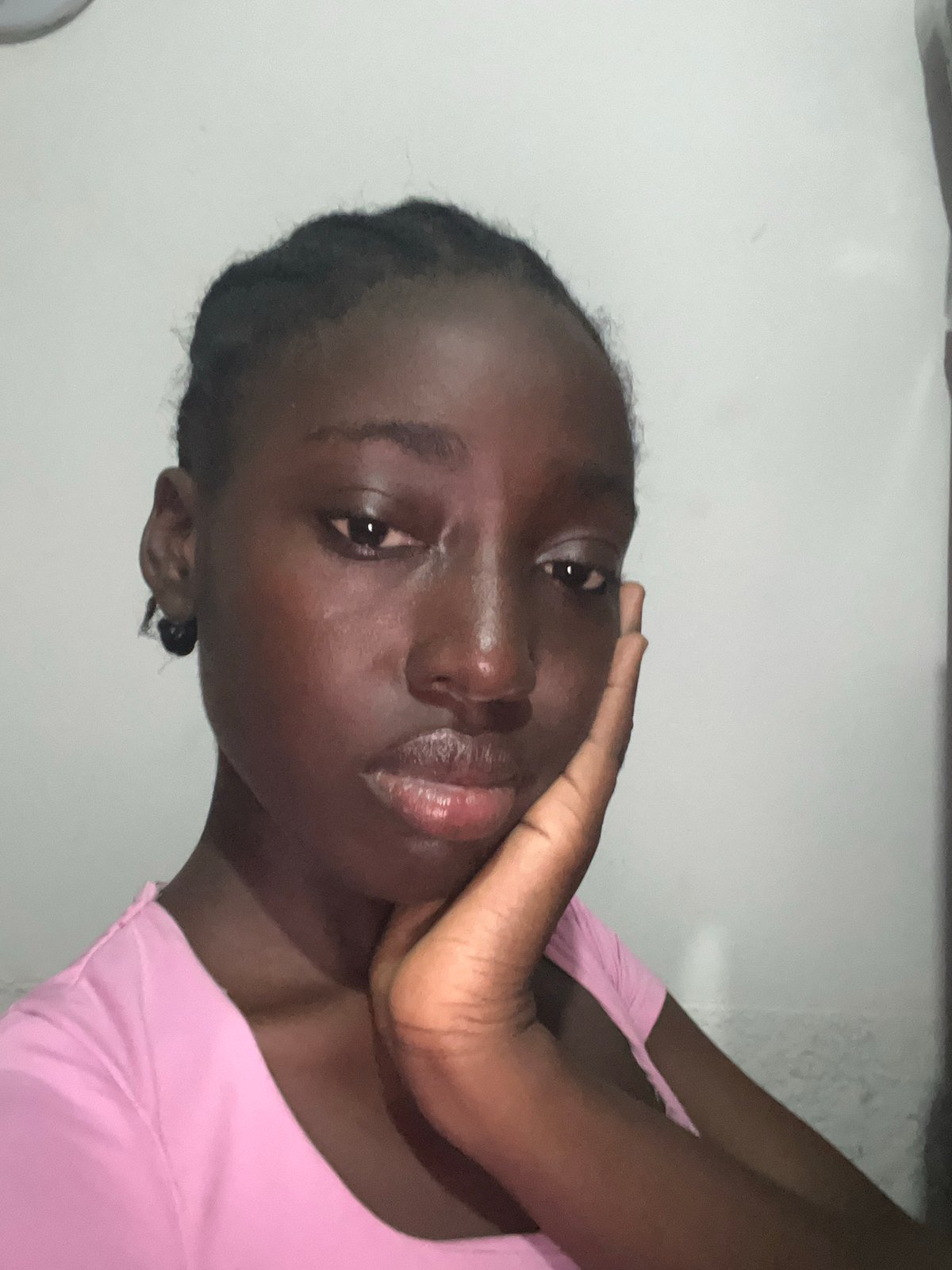 Woman photographs herself in bedroom with purple headboard, Abuja