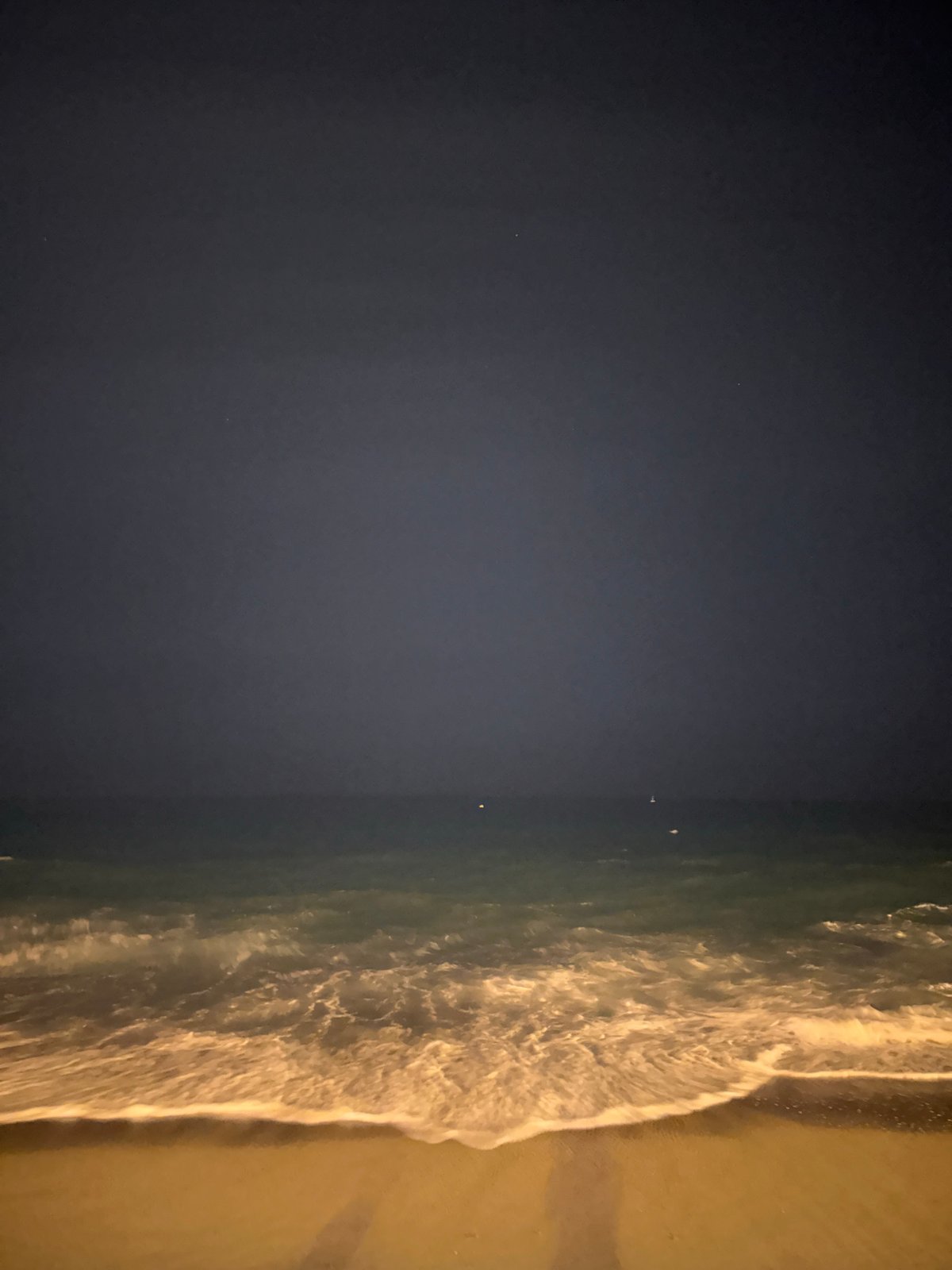 Late-night waves at Barceloneta with the W Hotel lit up behind