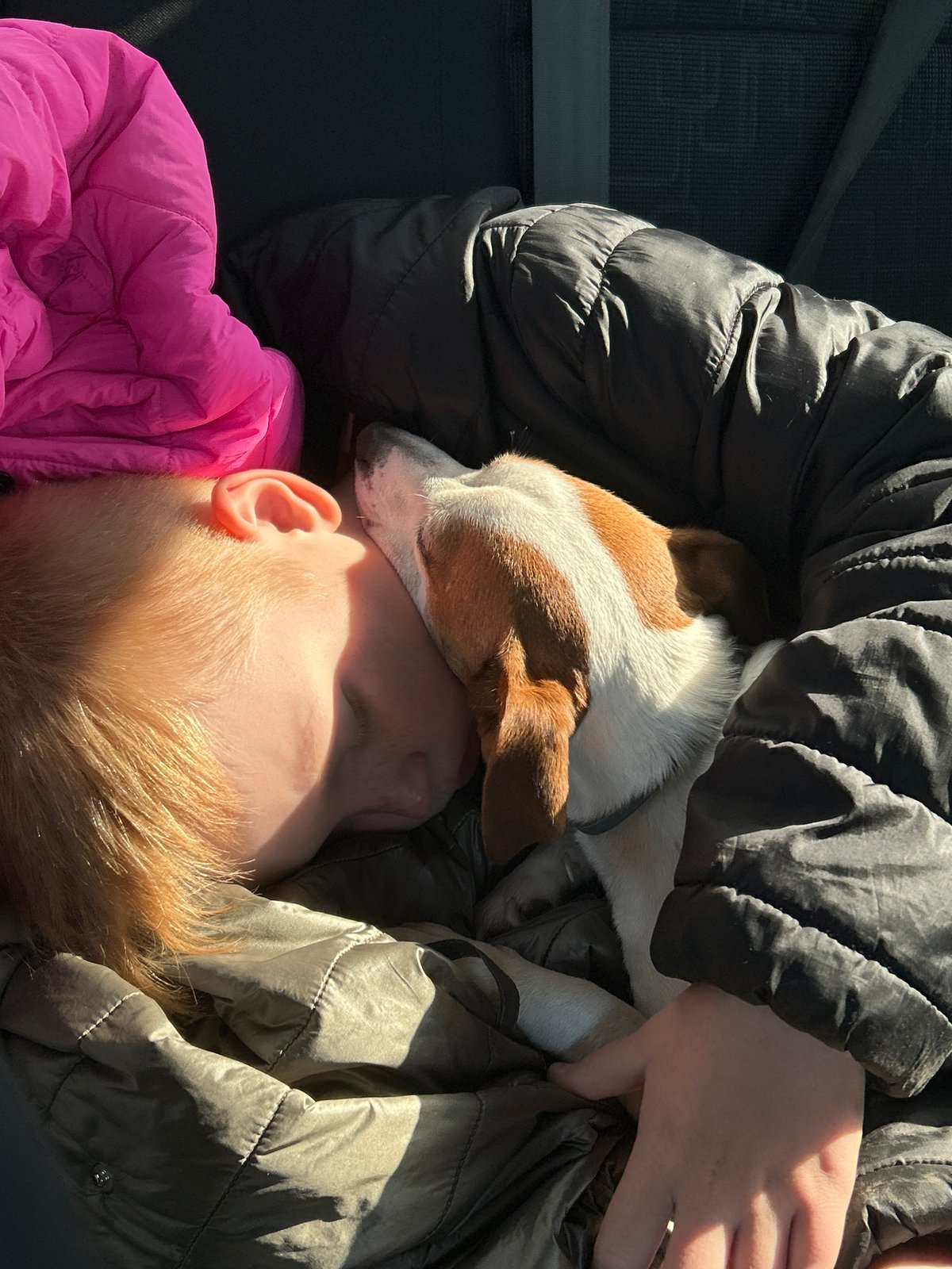 Child and dog sleep together in Russia
