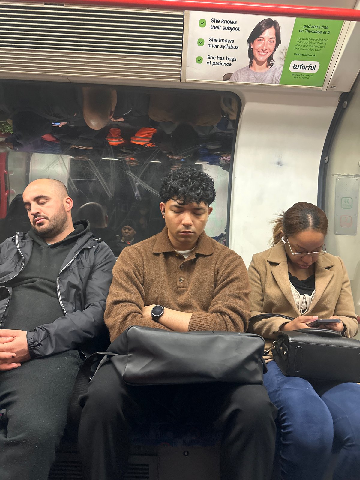 Morning commuters photographed aboard London Underground train