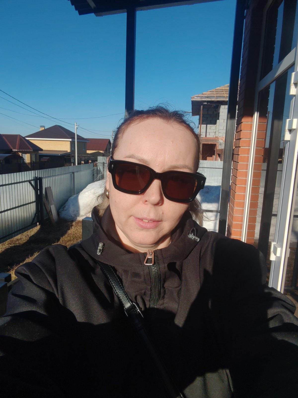 Woman takes selfie in residential Chaikovsky neighborhood