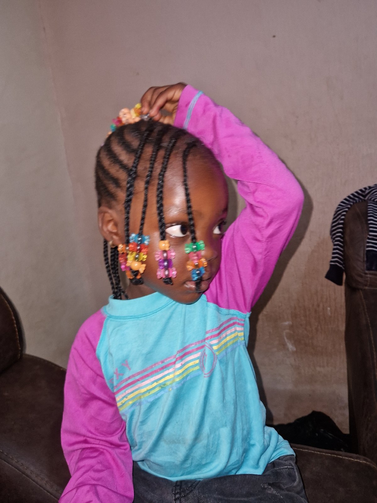 Casual indoor moments with colorful braids and Naira in hand