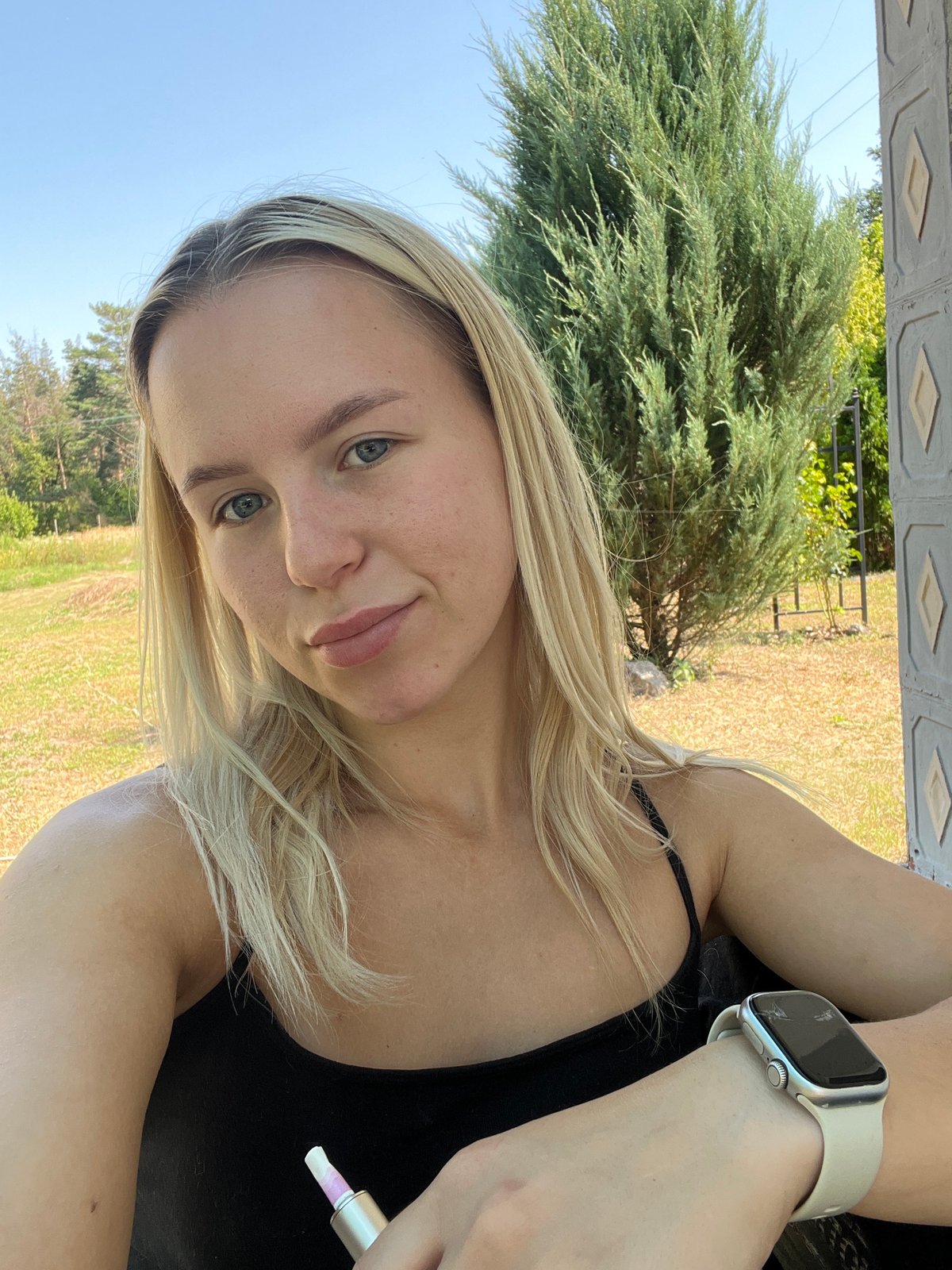 Outdoor selfie session near a decorative garden setting