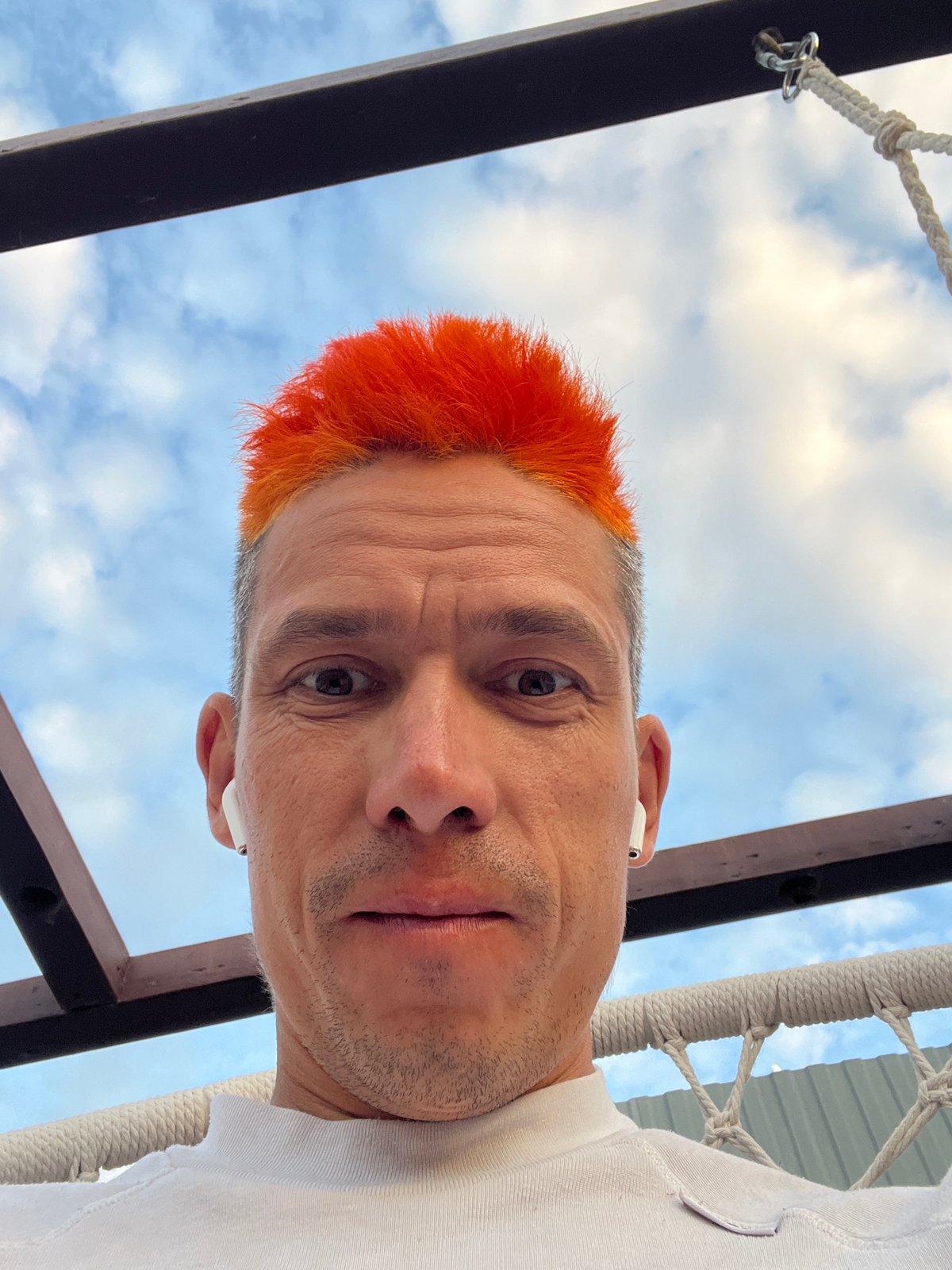 Orange-haired individual captures evening moments with cat in Chaikovsky