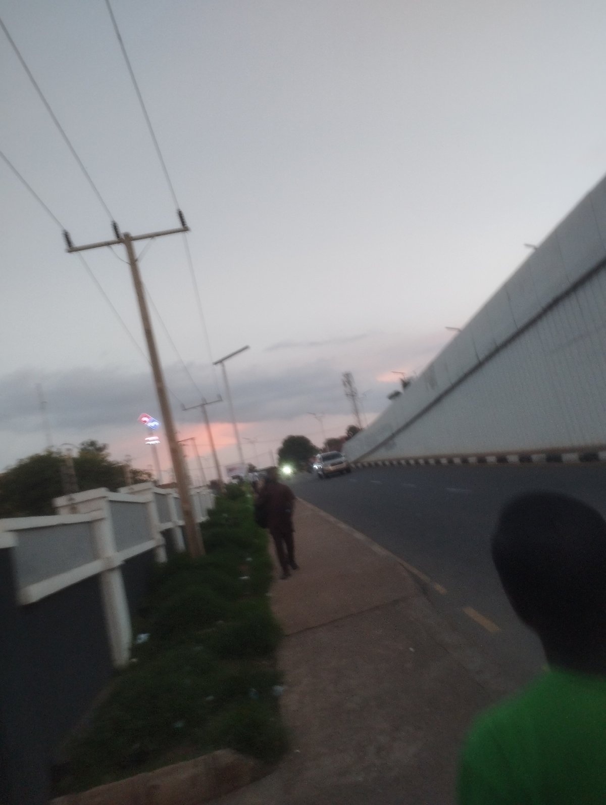 Dusk settles over a busy Jos road junction
