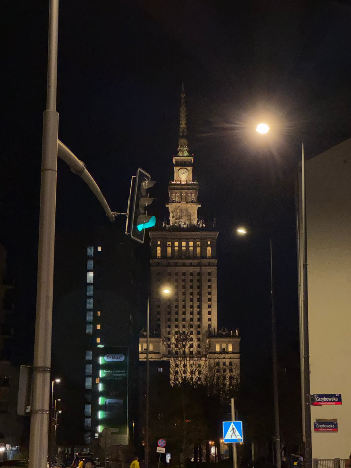 Full moon photographed above Warsaw's Palace of Culture