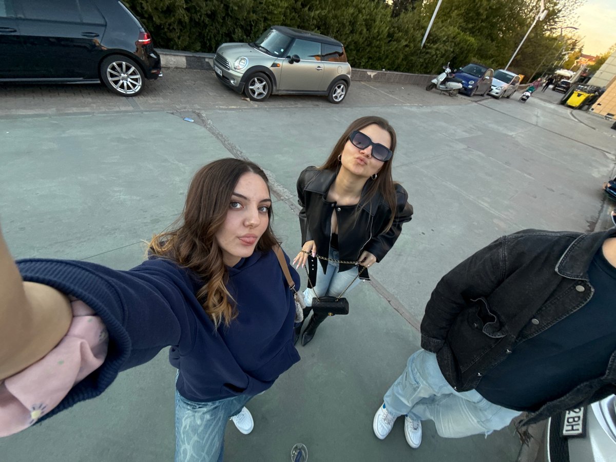Three people meet outdoors in Sofia, Bulgaria