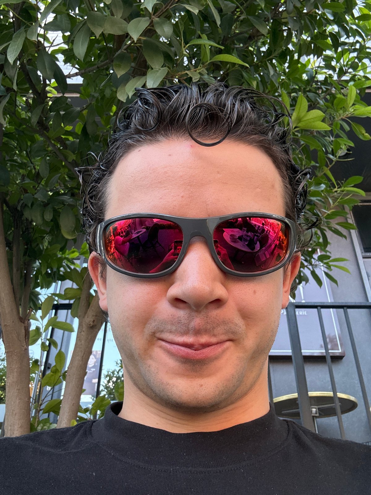 Man takes selfie with red-lens sunglasses in Tashkent restaurant