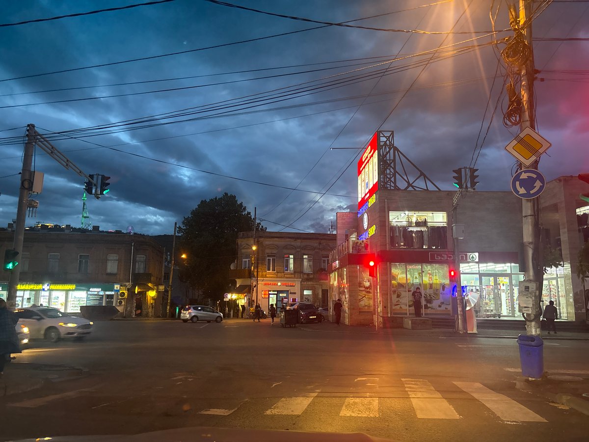 Evening street activity observed at Tbilisi intersection