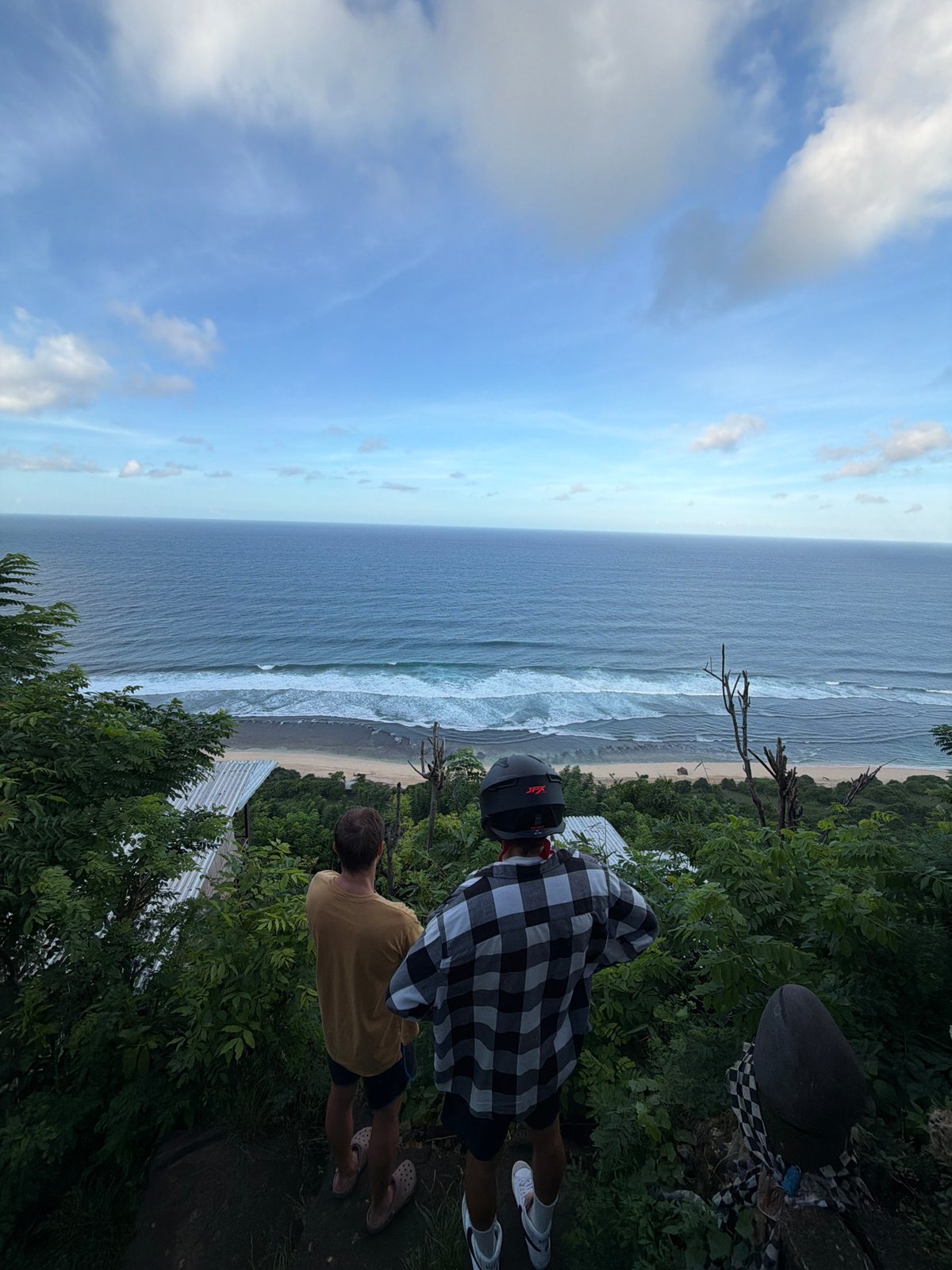 Two men visit monkey-populated oceanfront viewpoint in Kuta Selatan