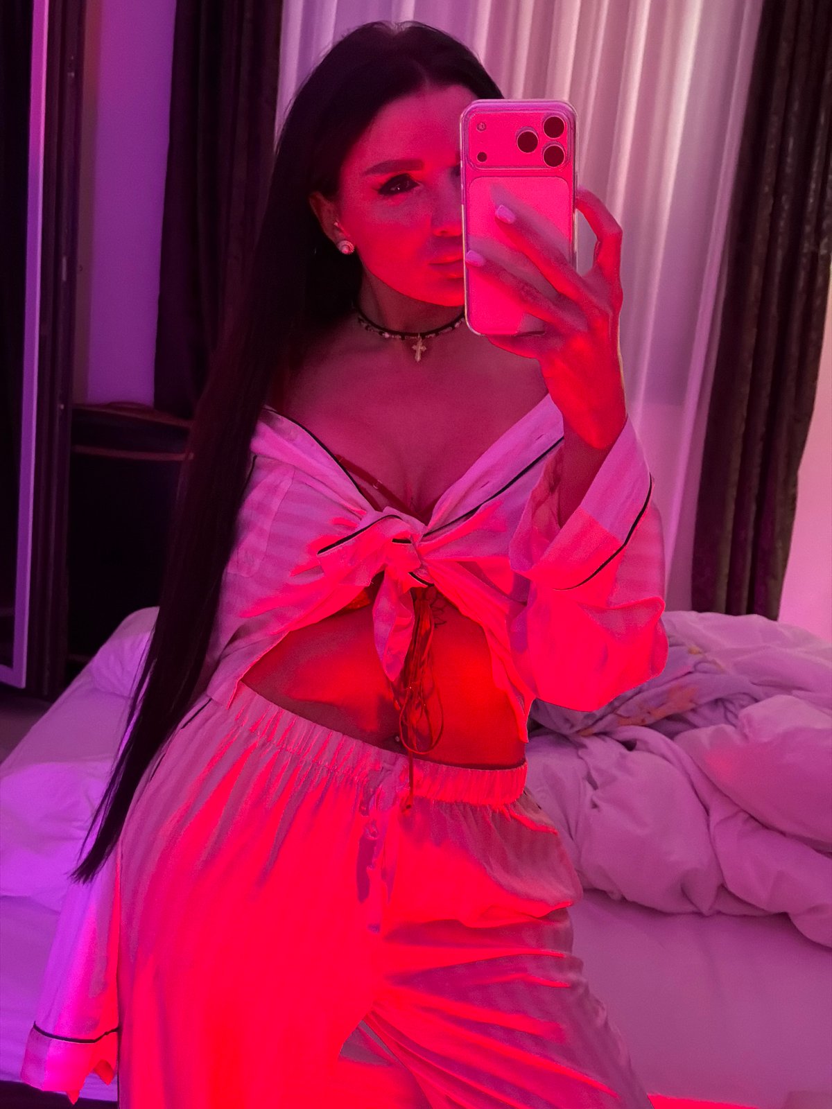 Mirror selfie taken in colorfully lit room in Montenegro