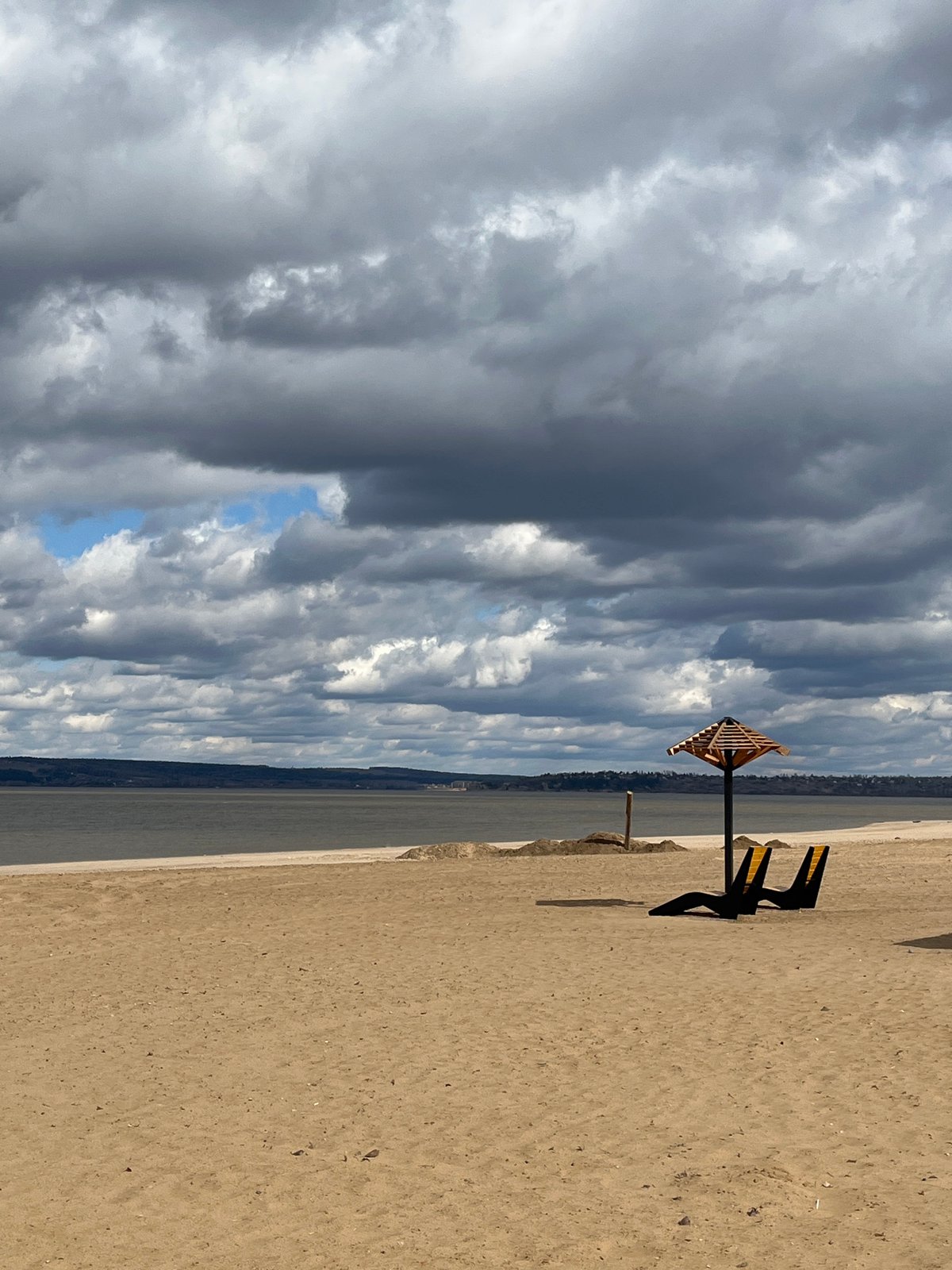 Sandy waterfront with modern structures documented in Perm, Russia