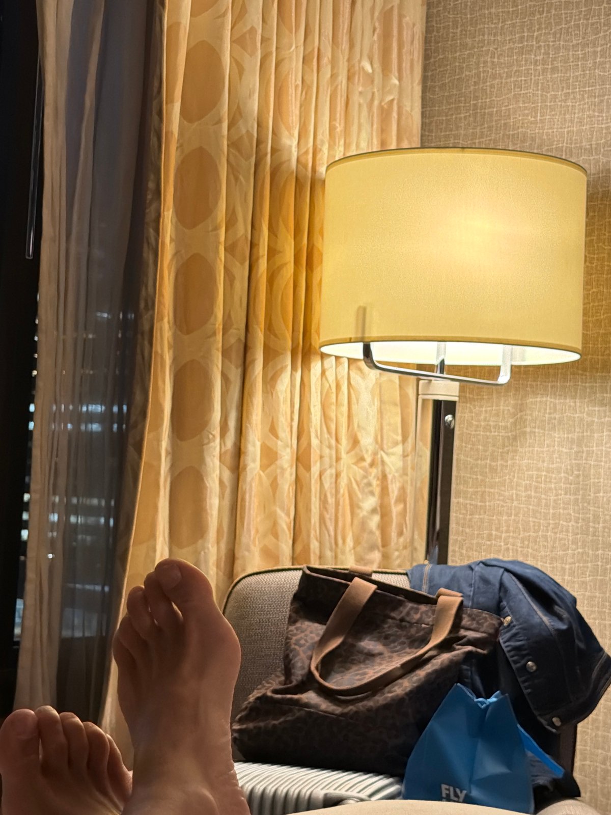 Person rests bare feet in Toronto hotel room
