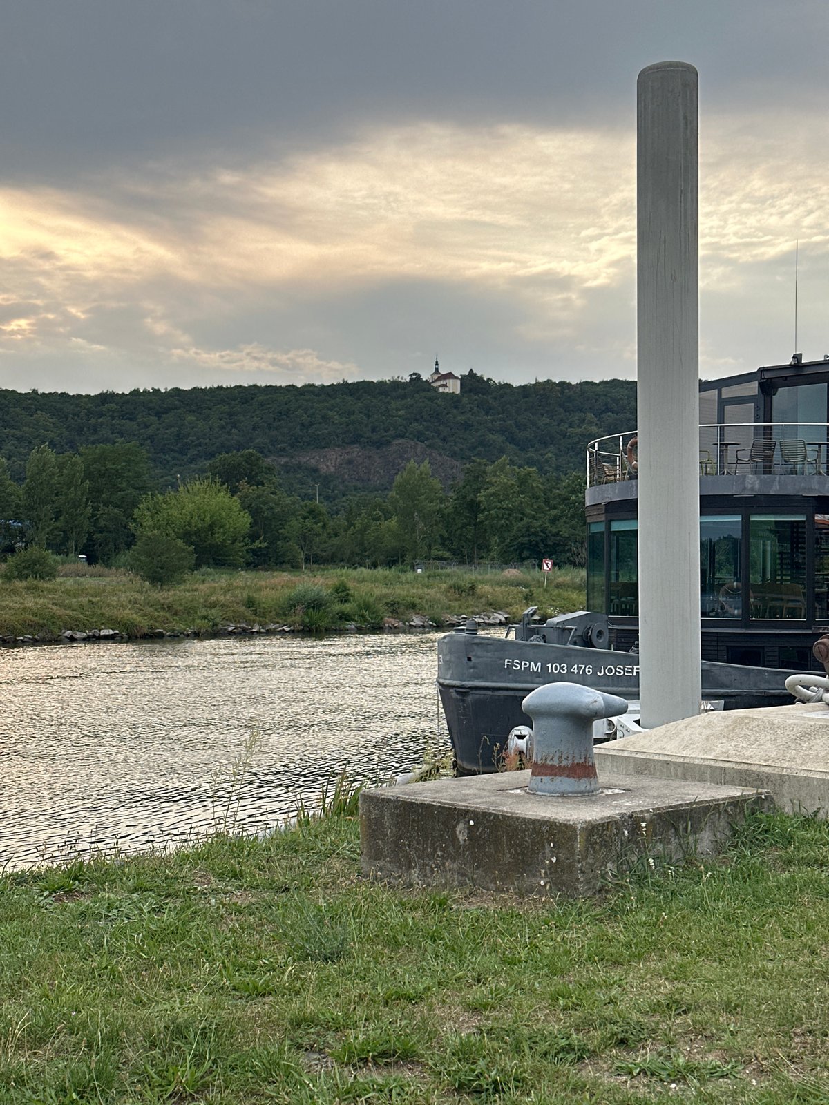 Cloudy afternoon along a riverside walkway with coffee in hand