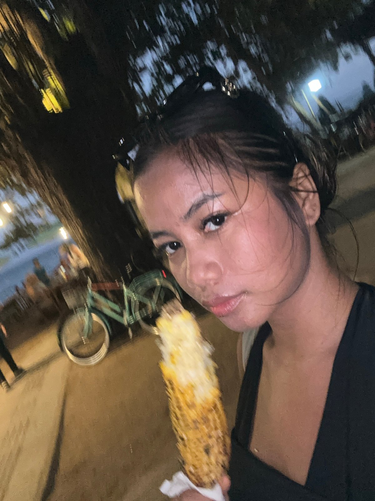 Casual beach day documented in Denpasar with corn vendors, tourists