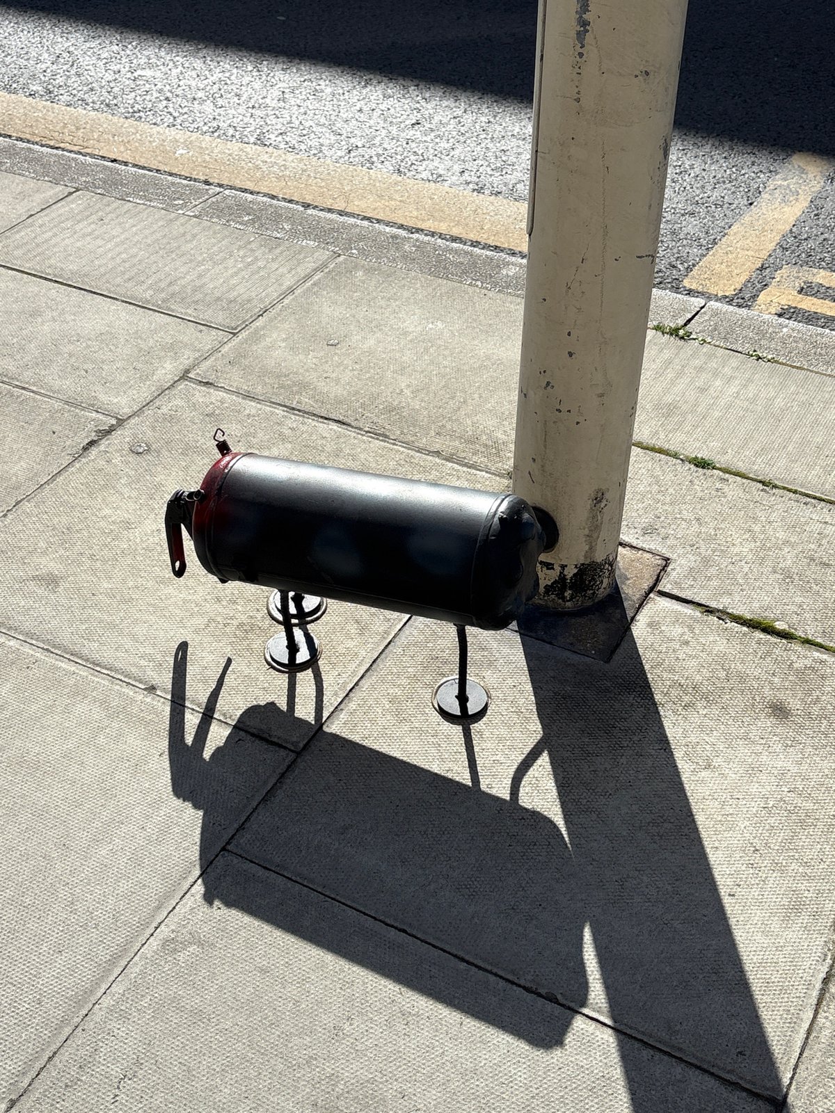 Street-mounted cylindrical object documented in London