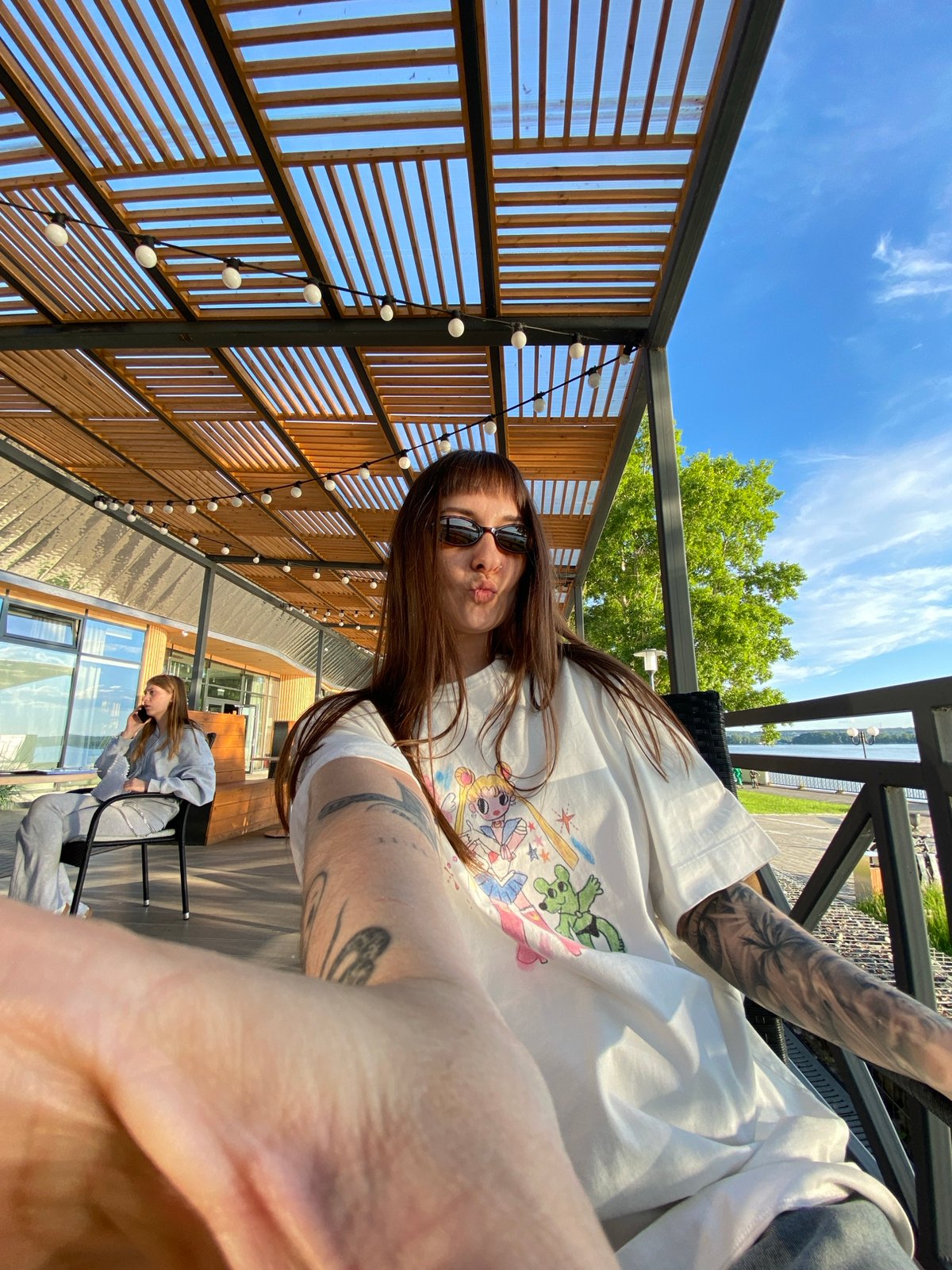 Friends gather at waterfront cafe in Votkinsk for afternoon drinks