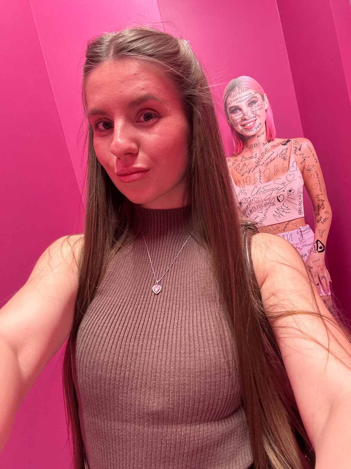 Women take selfies at pink-themed art installation in Moscow