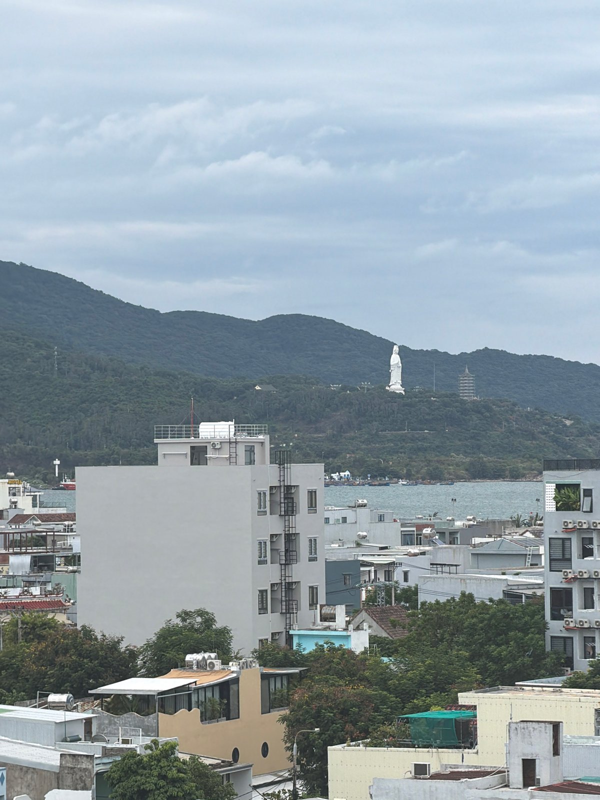 Drone and ground views of a cloudy coastal cityscape