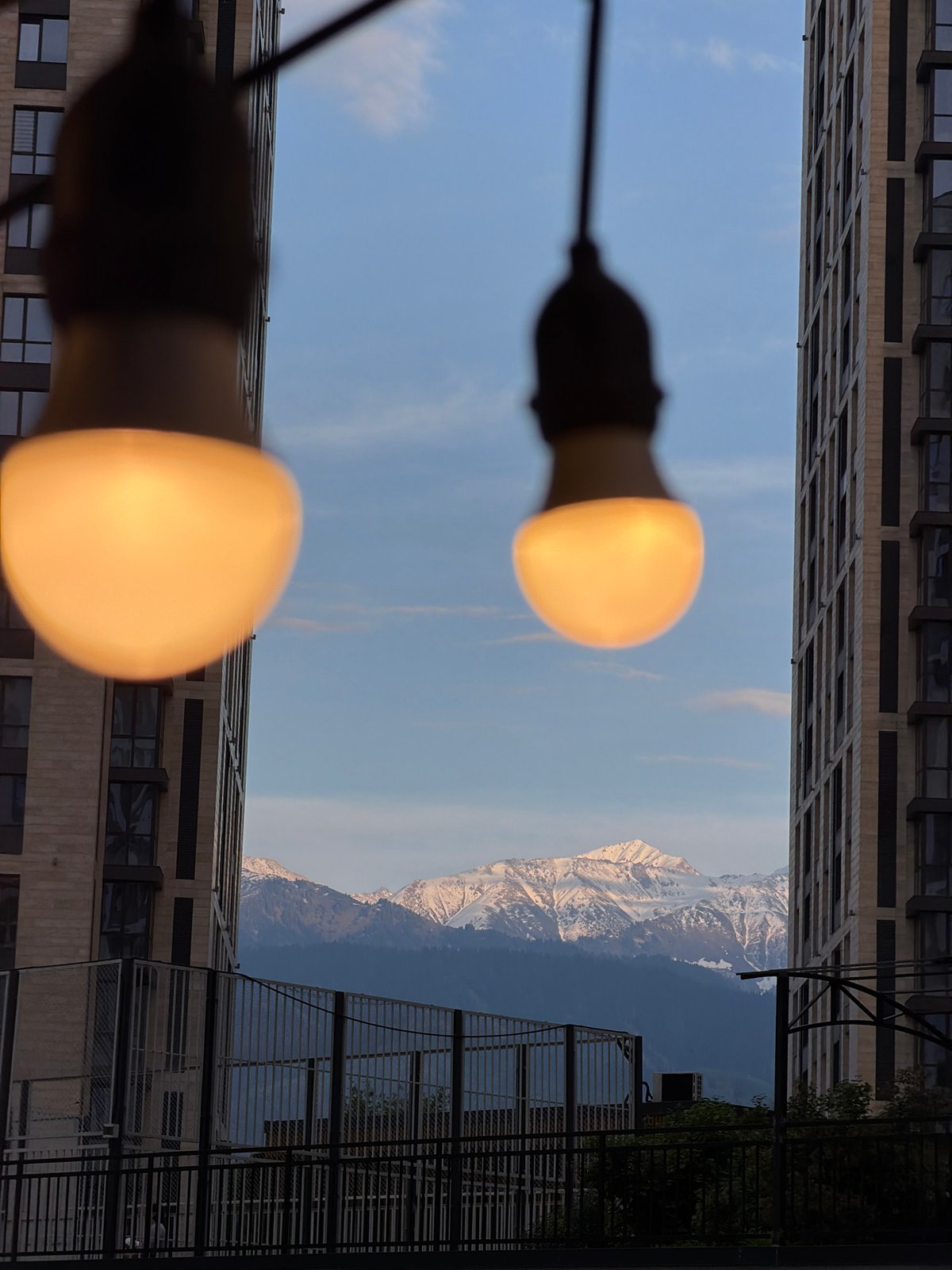 Almaty resident captures Tian Shan mountain views between city buildings