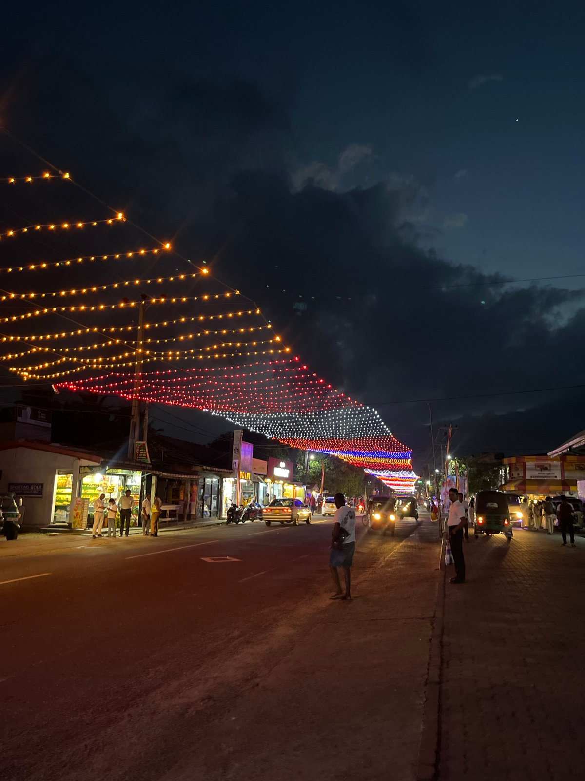 Habaraduwa lit up for a festive street celebration at dusk