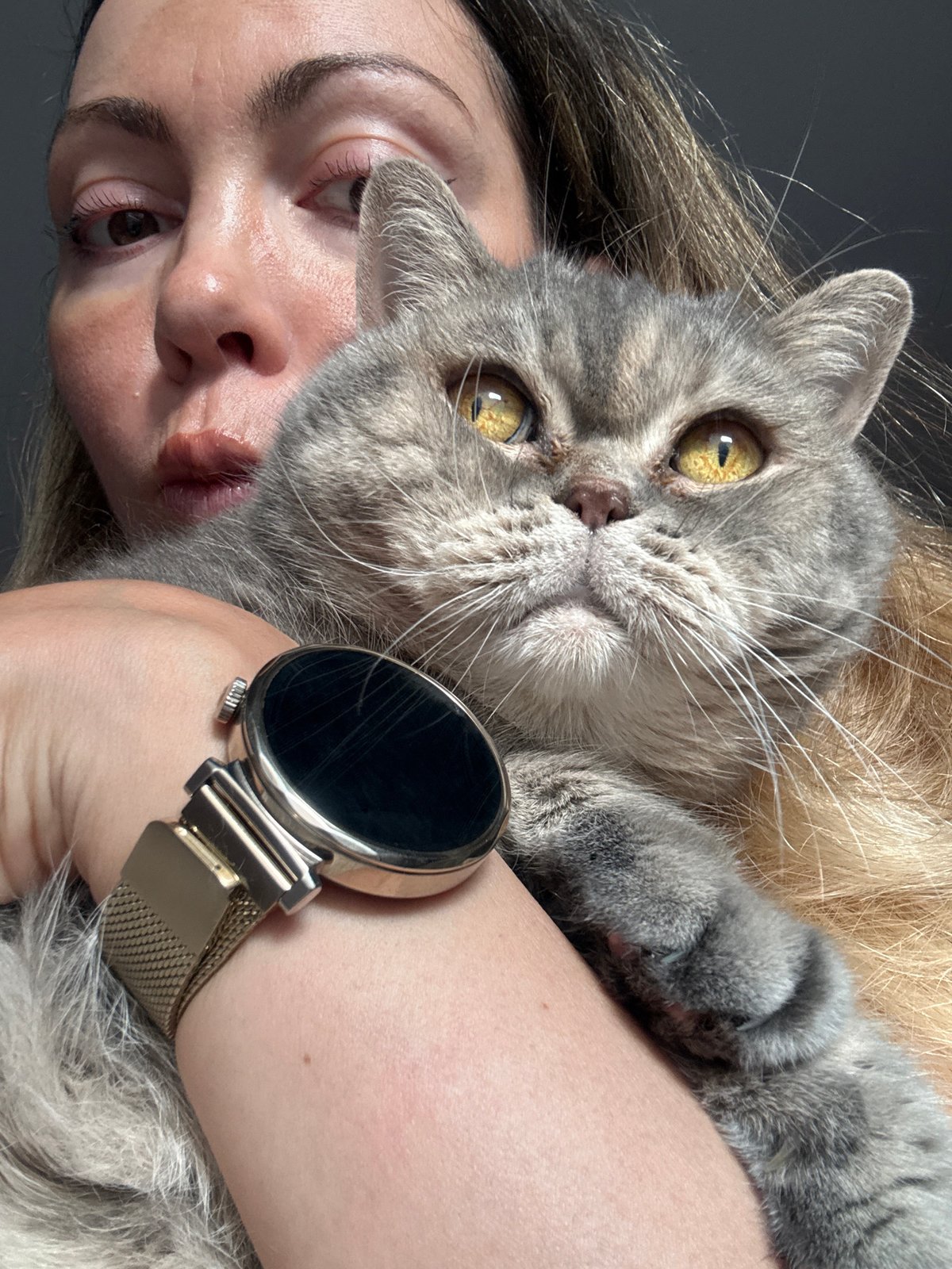 Woman embraces grey cat in intimate portrait in Nesebar