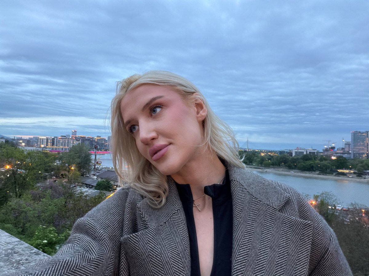Woman photographed at waterside during dusk in Belgrade