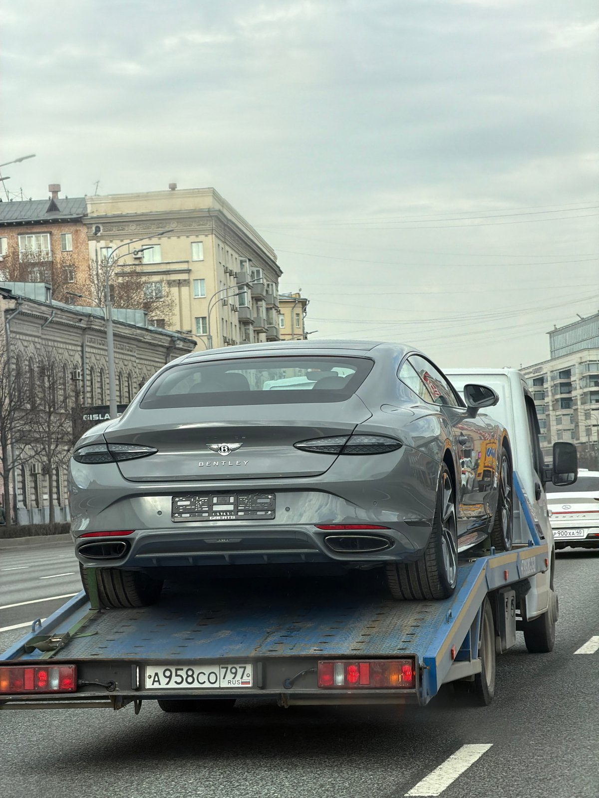 Bentley Continental GT transported on flatbed truck in Moscow