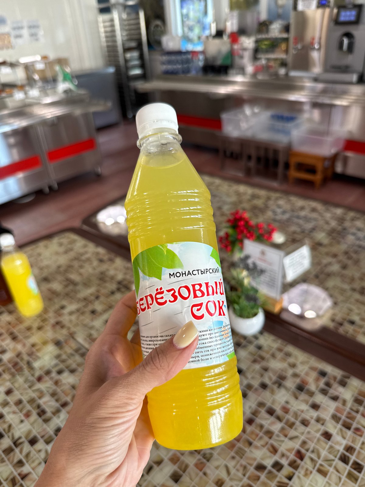 Person holds yellow liquid bottle in close-up photograph