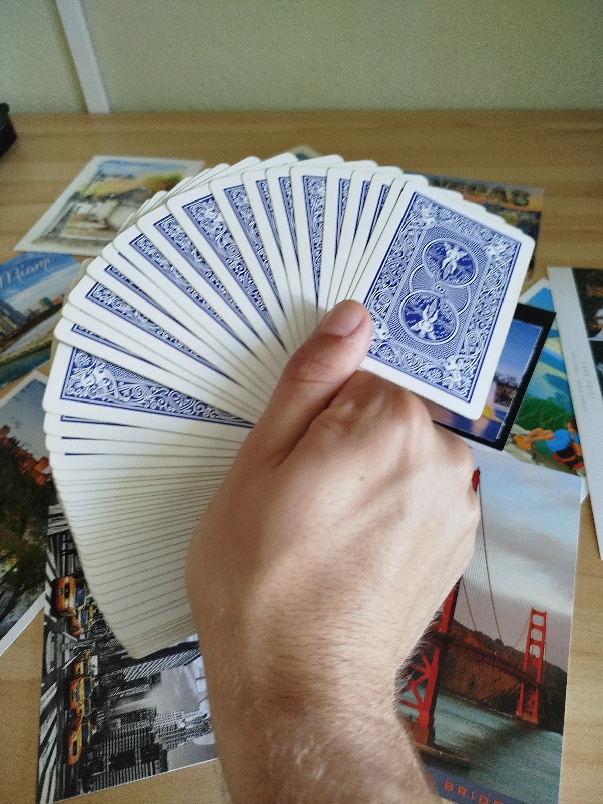 Postcards and playing cards spread across a table in Varna